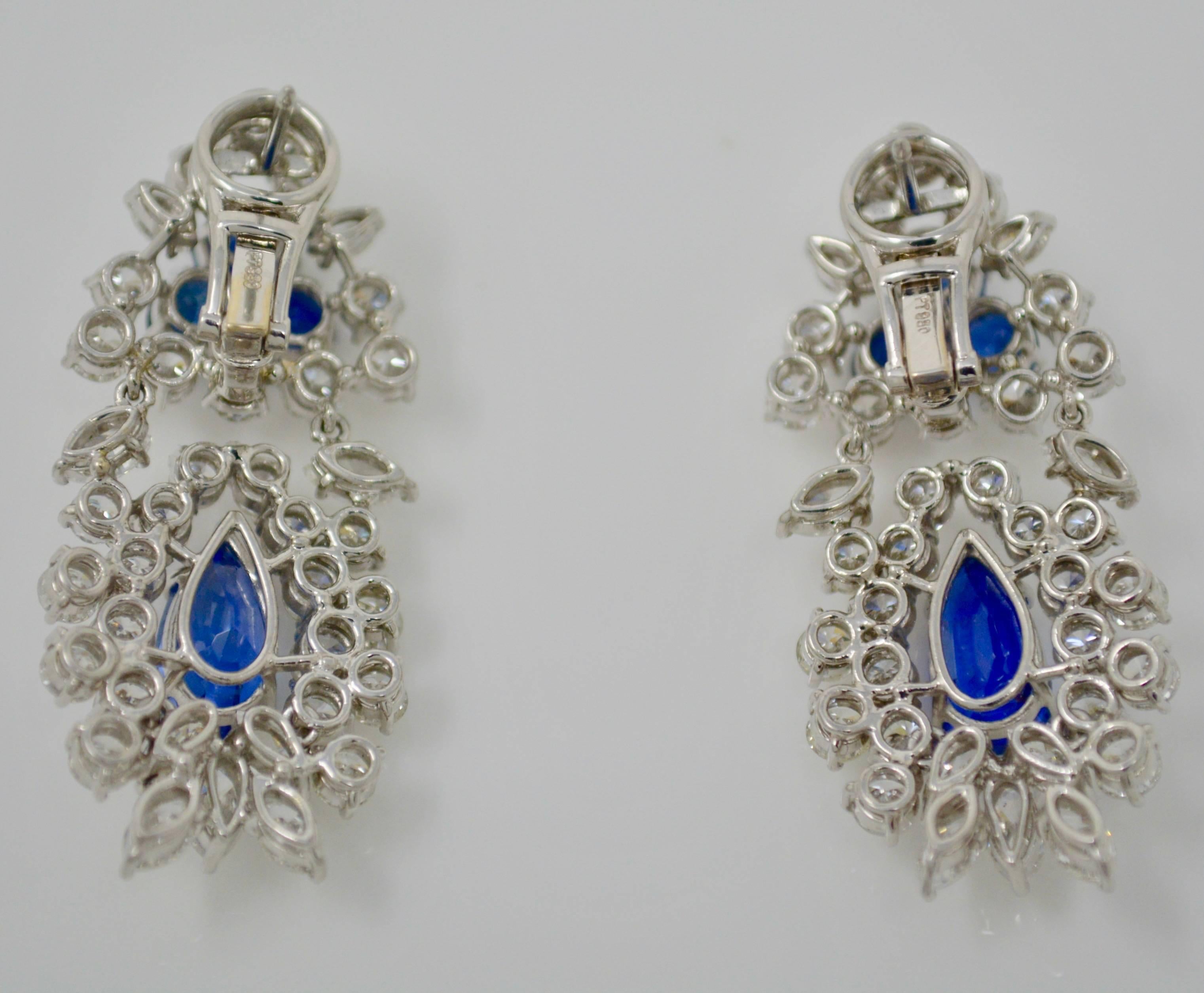 These lovely and detailed earrings are feminine, elegant, classy and wearable . They are made of platinum and features two pear shape blue sapphire weighing 2.98 CTS and 2.73 CTS and two round sapphire on top with a surround of round brilliant cut