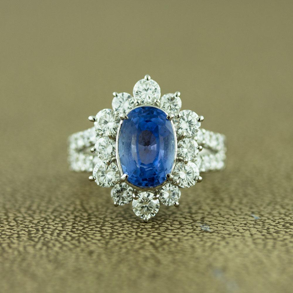 A rare unheated blue sapphire from Sri Lanka, formerly known as Ceylon, is set atop this special ring. It weighs 4.86 carats and is cut as an oval shape. It is surrounded by 1.83 carats or round brilliant cut diamonds which are set on the shoulders