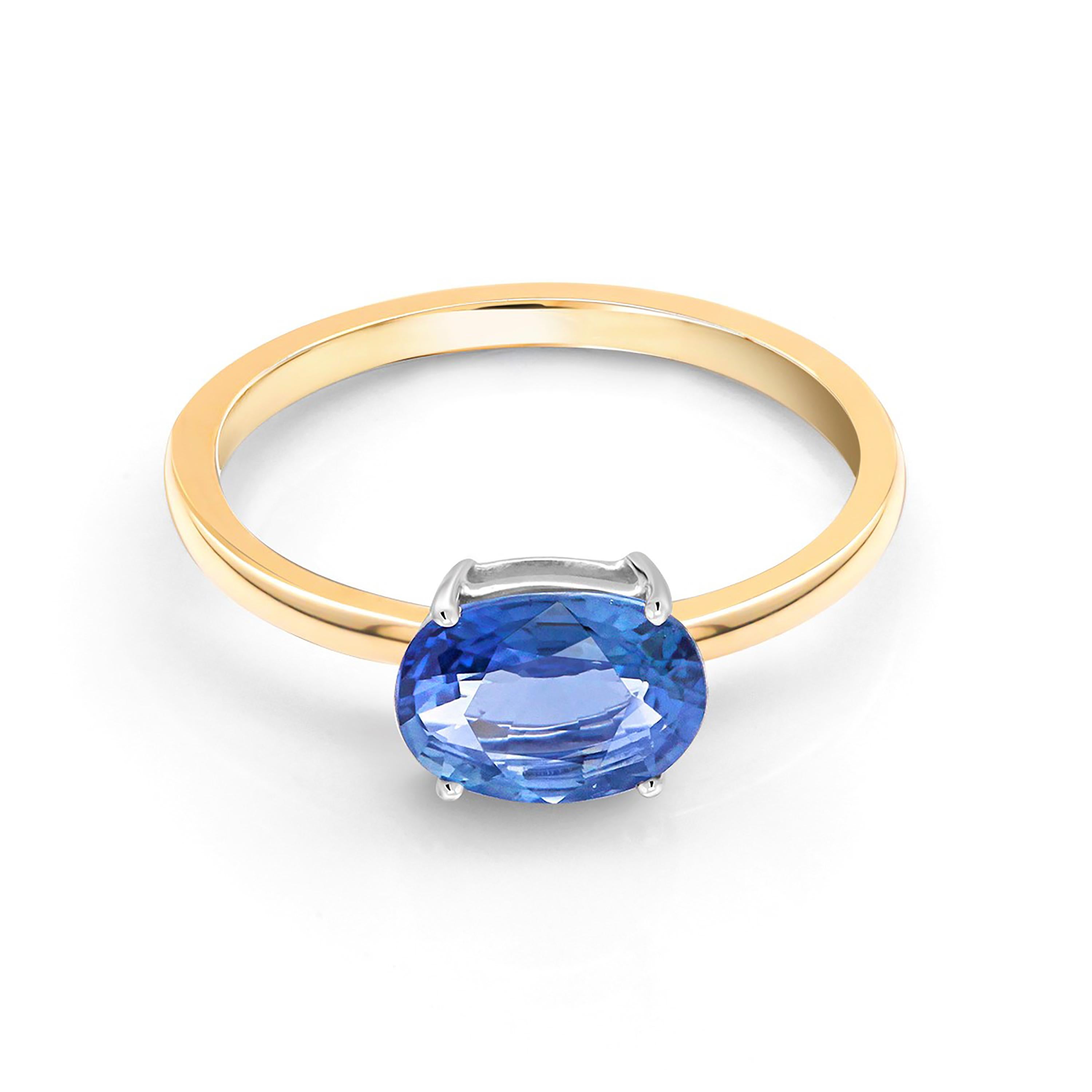 Fourteen karats white and yellow gold solitaire cocktail or stacking ring
Bright Ceylon oval-shaped blue sapphire weighing 1.40 carats                                                                       
Ring size 7 In Stock
The ring can be