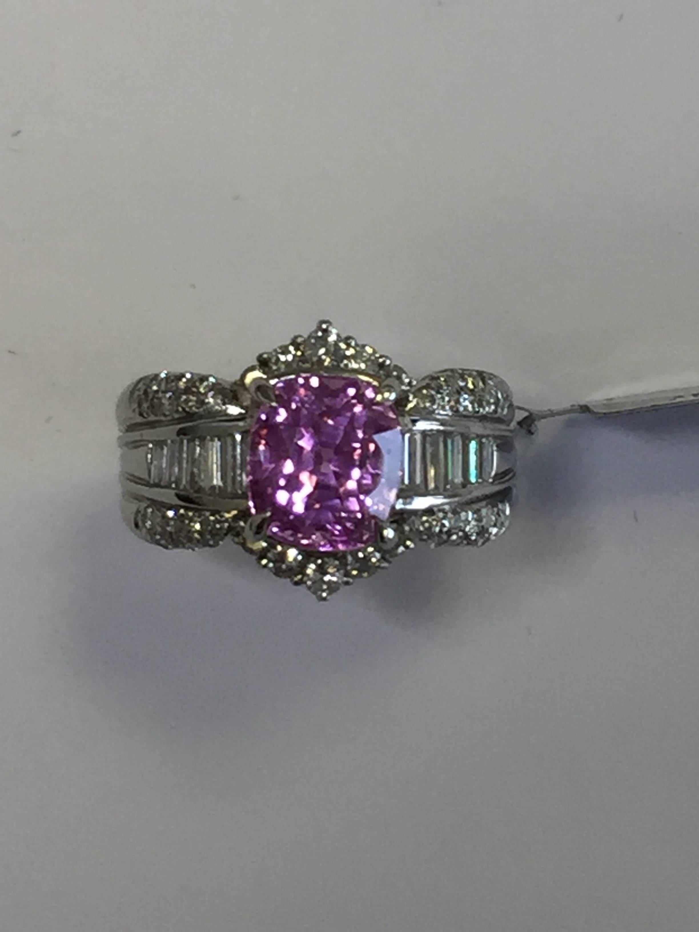 4.61 carat gorgeous Ceylon pink sapphire cushion with 0.94 carats of white diamond baguettes and rounds in platinum mounting.  This cocktail ring is perfect for any occasion and will compliment any outfit because of the bright pink shade!  Size 6.75.