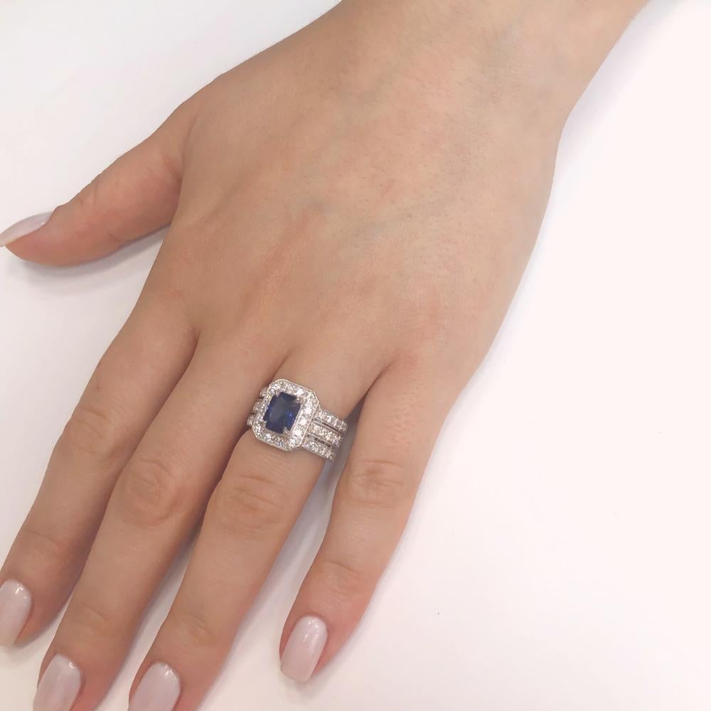 A classic yet bold art deco inspired cocktail ring.
Strong deep blue sapphire center emerald cut stone 1.98 ct from Ceylon.
White round diamonds 2.12 ct in G-H Color Clarity VS adorns this 3 layered platinum 950 band at the front. 
Unisex