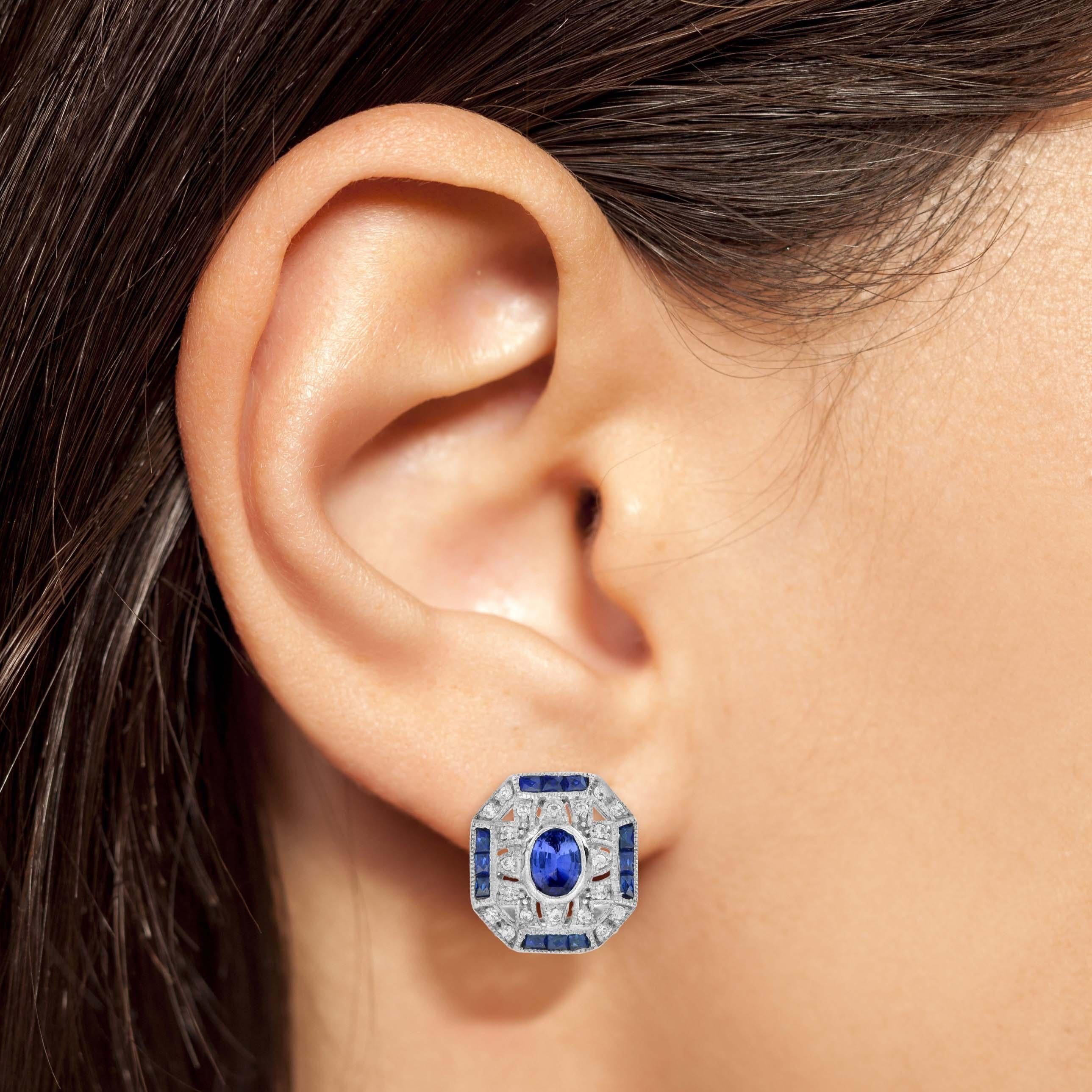 At the center, a brilliant round diamond catches the light, surrounded by sleek, black onyx and framed with a sparkling diamonds. The geometric lines and angular details of the Art Deco style enhance the earrings’ vintage allure, making them a