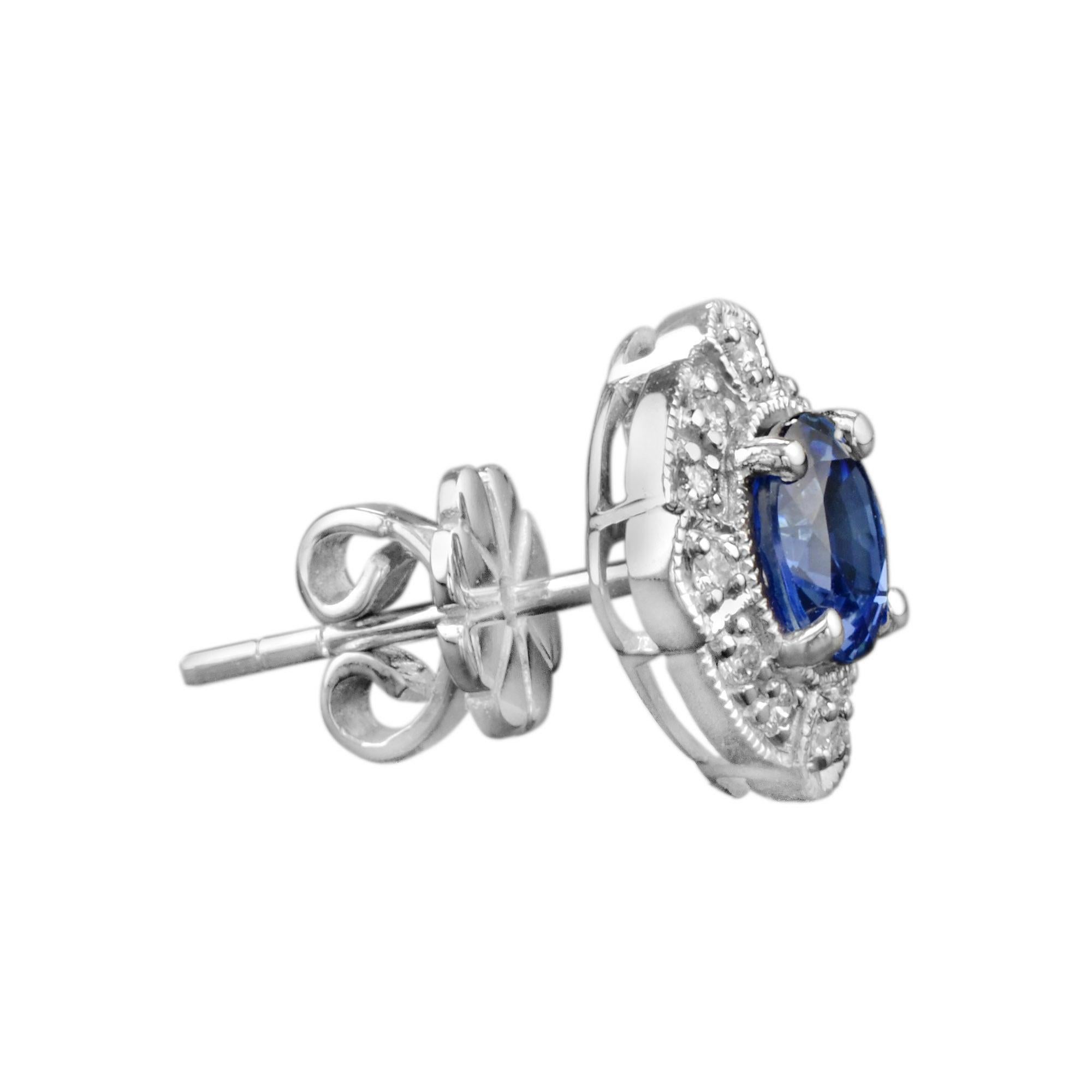 These gorgeous Ceylon sapphire and diamond stud earrings have been crafted from the finest 18K white gold. A stunning surface polish has been applied to the surface of earrings to bring out the deep hue of the round cut sapphire gemstone hold at the