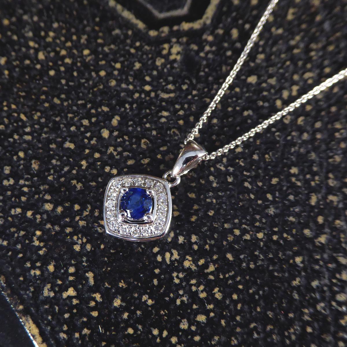 This necklace features a stunning Ceylon sapphire at its heart, renowned for its vibrant, deep blue hue that captures the essence of the exotic landscapes of Sri Lanka. The sapphire is beautifully encircled by a halo of glittering diamonds, each one