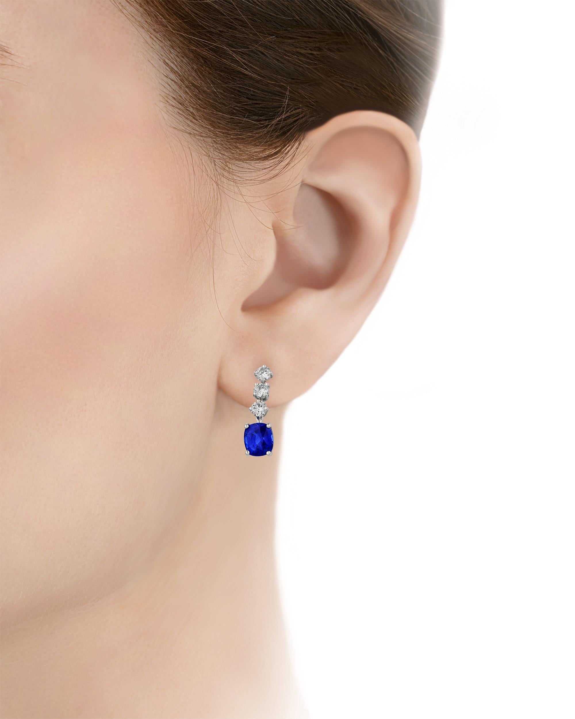 Featuring the luxurious royal blue hue for which the stones are prized, two vividly hued sapphires totaling 4.24 carats form the final pendant in these drop earrings from famed American jeweler Oscar Heyman. The precious gemstones are certified by
