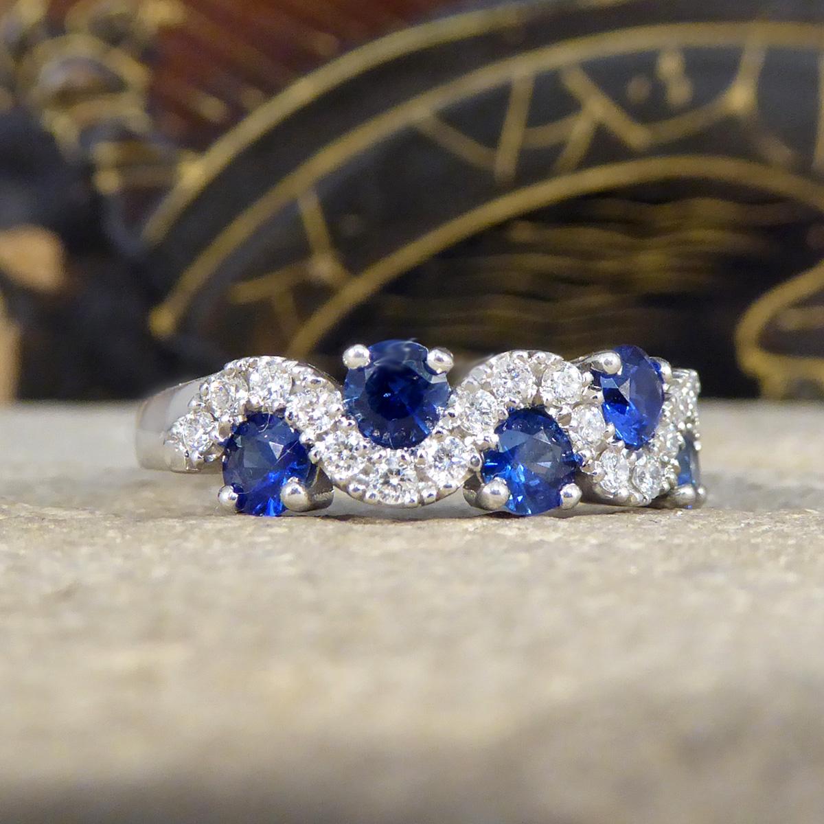 Embark on a journey of elegance with our Sapphire and Diamond 'Lazy River' ring, masterfully crafted in luxurious platinum. This exquisite piece captures the essence of serenity and grace, featuring five mesmerising Ceylon sapphires, renowned for
