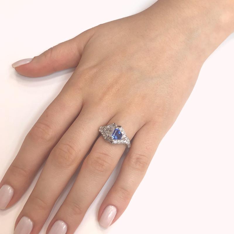 This Ceylon blue sapphire 1.22 ct with white diamond 0.97 ct  twin pair are in a triangle / trillion cut and placed juxtaposition against each other. 
Accents of smaller round natural white diamonds 0.35 ct.
Platinum 950 metal. 
Length: 1.2