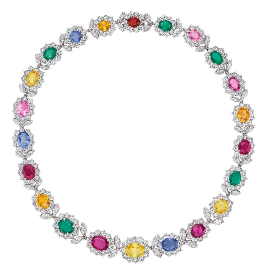 Crafted with unparalleled artistry, this platinum ensemble showcases a link necklace, bracelet, and earrings adorned with a captivating array of multicolor Ceylon Sapphires, Brazilian Emeralds, and Burma Spinels. Elevate your style with the allure
