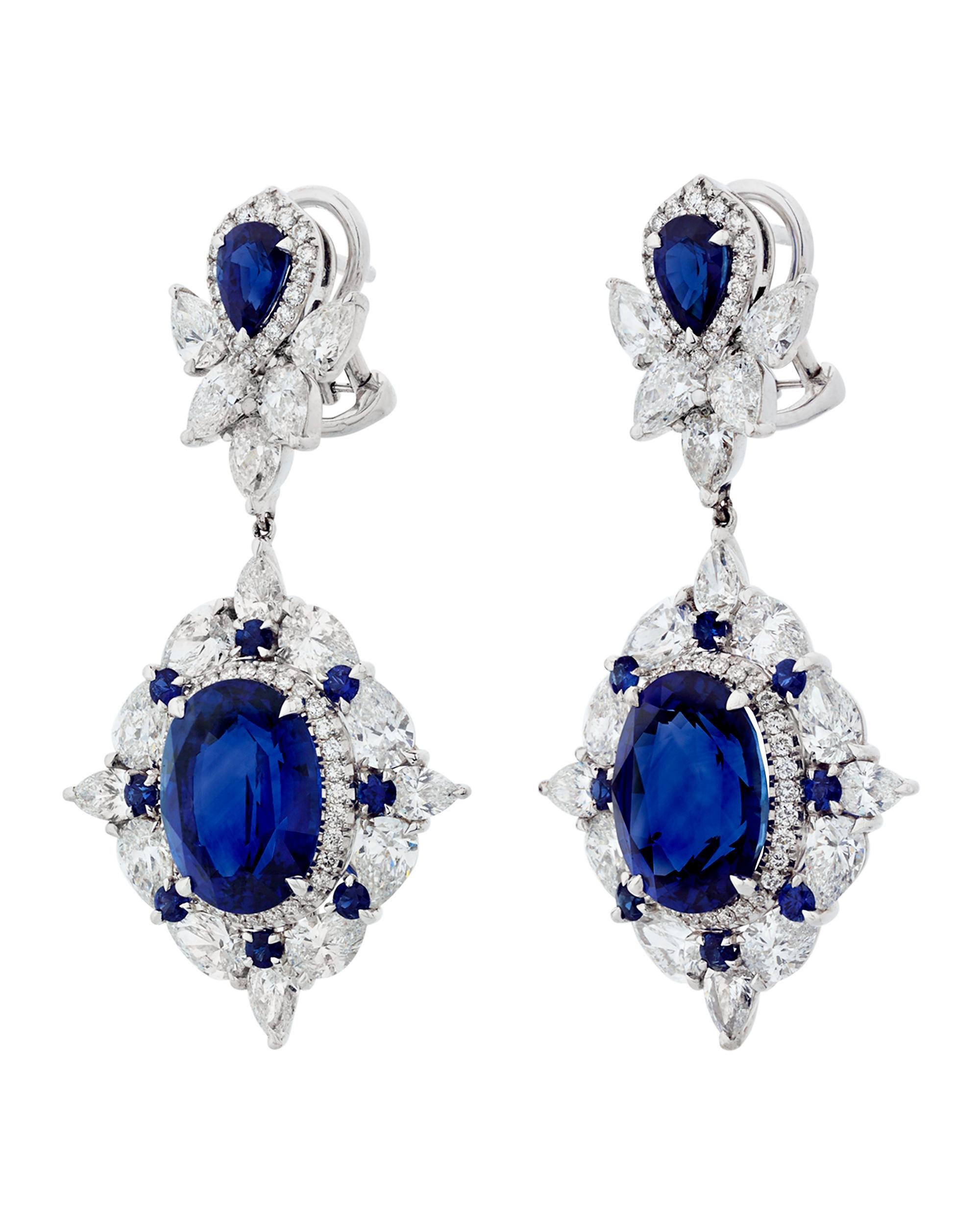 The 10.80 carats of sapphires in these graceful dangle earrings bear the unmistakable, velvety blue color of sapphires hailing from Ceylon, or modern-day Sri Lanka. Accompanying these glorious blue jewels are 2.12 total carats of lush white