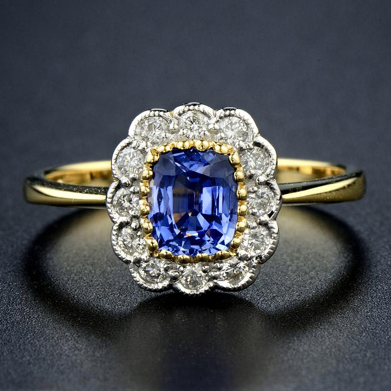 This vintage style ring was made in 18K Gold.   

The ring consists of... 
Center is Natural Ceylon Sapphire from Srilanka 0.92 ct. 
Diamond 0.23 ct.   

The ring was made in size US#7