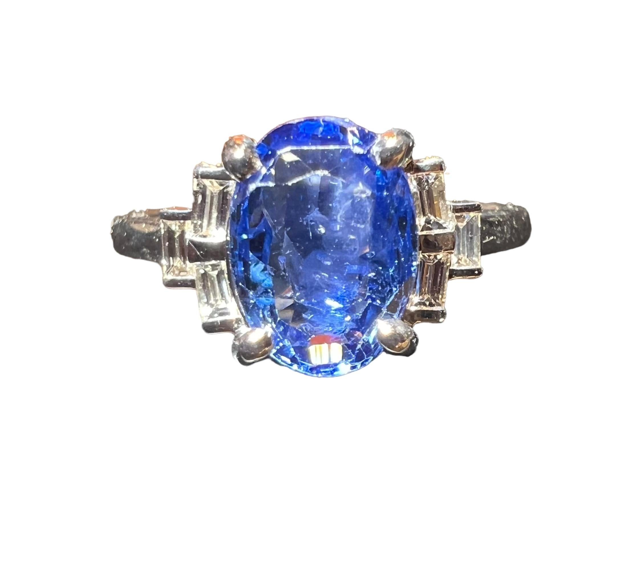 Superb bright-blue Ceylon sapphire, the stone is a deep, bright, translucent blue with natural inclusions.

the faceted oval sapphire ( measuring approx. 0.80 by 0.65 cm )

weighing 2.25 ct, it is surrounded by 0.18 carats of calibrated
