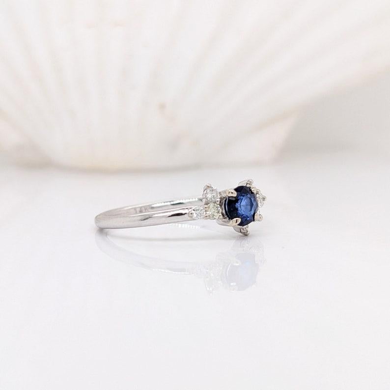 This cool offset diamond accent design ring features a royal blue Ceylon sapphire in 14k white gold. A unique ring design perfect for an eye catching engagement or anniversary. This ring also makes a beautiful birthstone ring for your loved