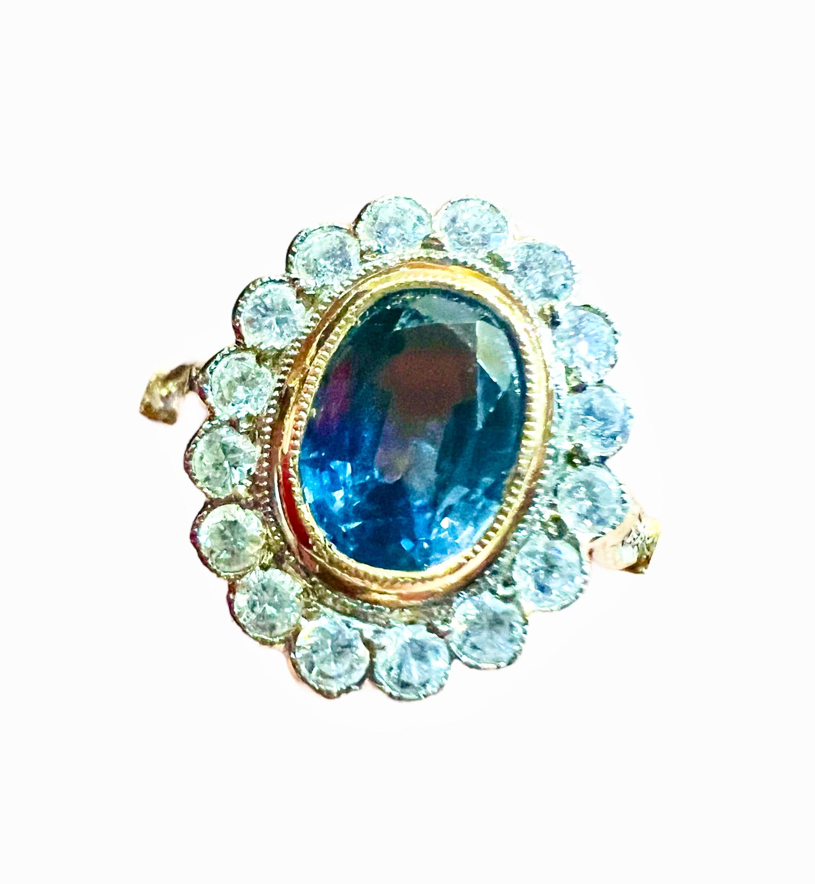 Oval Cut Ceylon sapphire ring, surrounded by diamonds in 18 carat yellow gold
