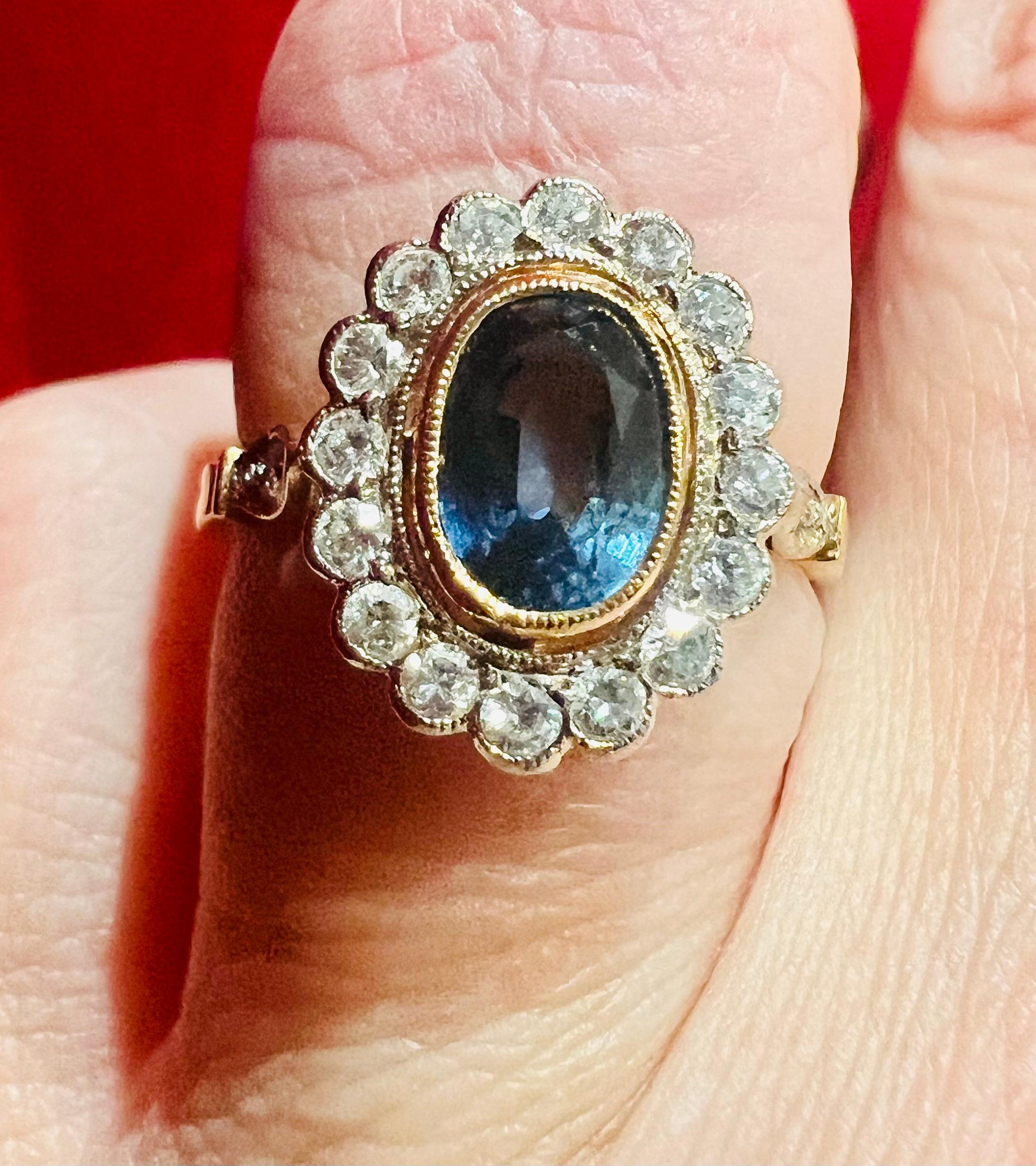Ceylon sapphire ring, surrounded by diamonds in 18 carat yellow gold