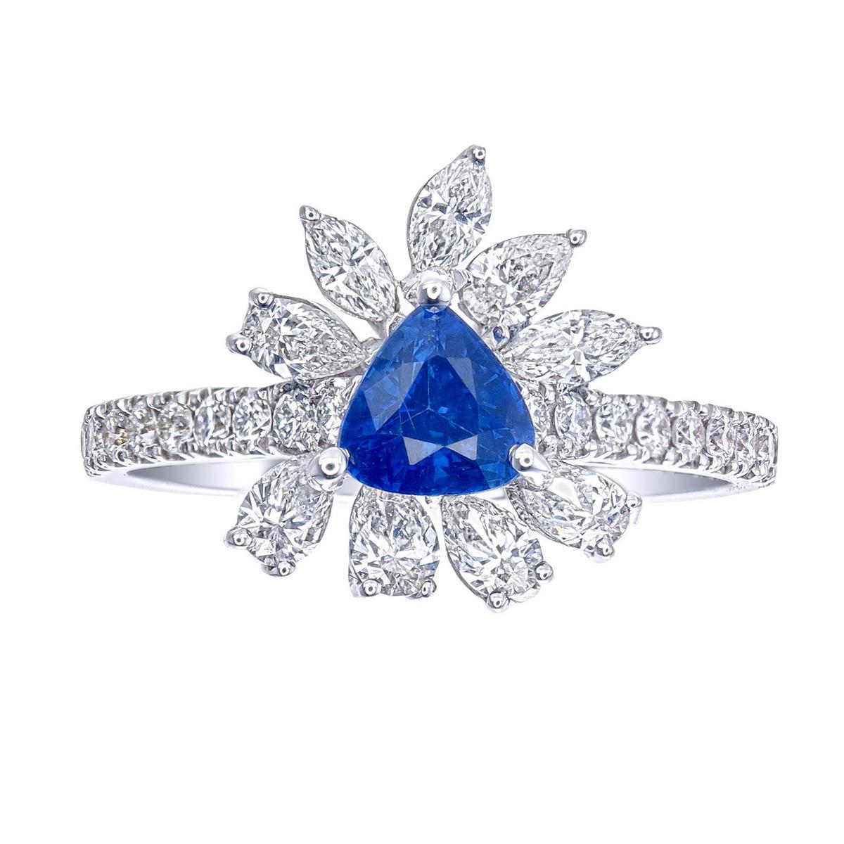 18kt white gold sapphire ring with diamonds
  
  Gold colour & karat: White gold 18kt
  Weight: 5.349 grams
  
  Set with-
  Stone type: Sapphire
  Shape: Trilliant
  Carat: 0.78 
  Colour: -
  Clarity: -
  
  Surrounding Stones: Diamonds
 1) Side