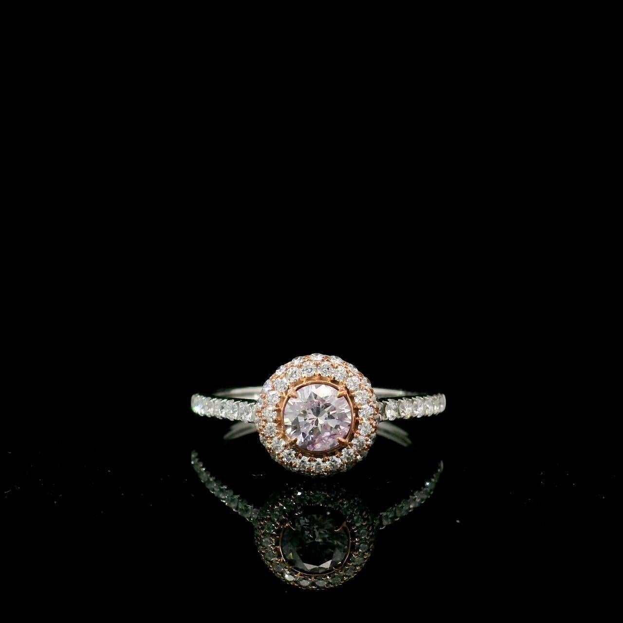 18kt white gold ring with diamonds
  
  Gold colour & karat: White gold 18kt
  Weight: 2.70 grams
  
  Set with-
  Stone type: Diamonds
  Shape: Round
  Carat: 0.31 ct
  Colour: Faint Pink
  Clarity: SI1
  
  Surrounding Stones: Diamonds
 1) White