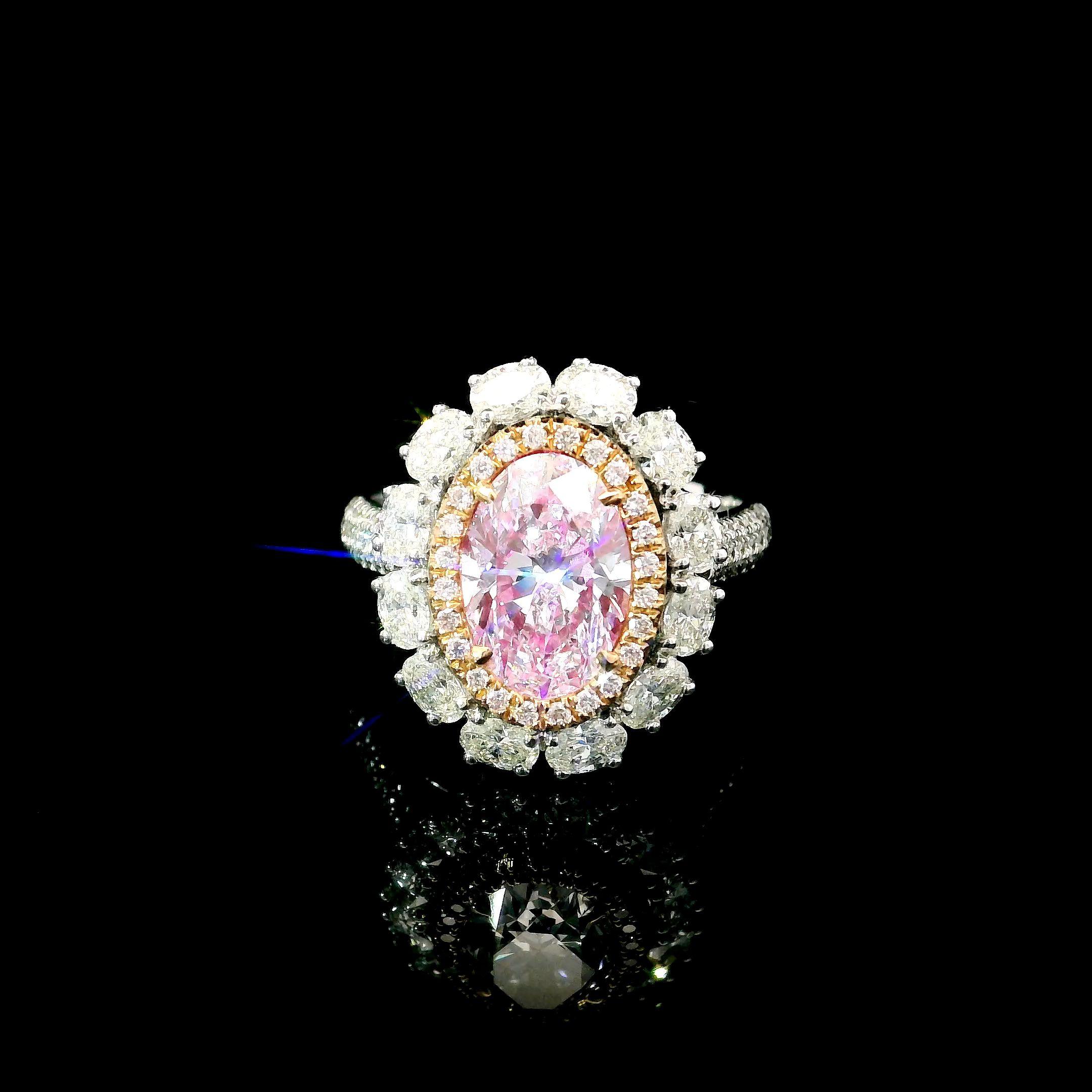 18kt white gold ring with diamonds
  
  Gold colour & karat: White gold 18kt
  Weight: 6.25 grams
  
  Set with-
  Stone type: Diamonds
  Shape: Oval
  Carat: 1.90 ct
  Colour: Faint Pink
  Clarity: VVS2
  
  Surrounding Stones: Diamonds
 1) White