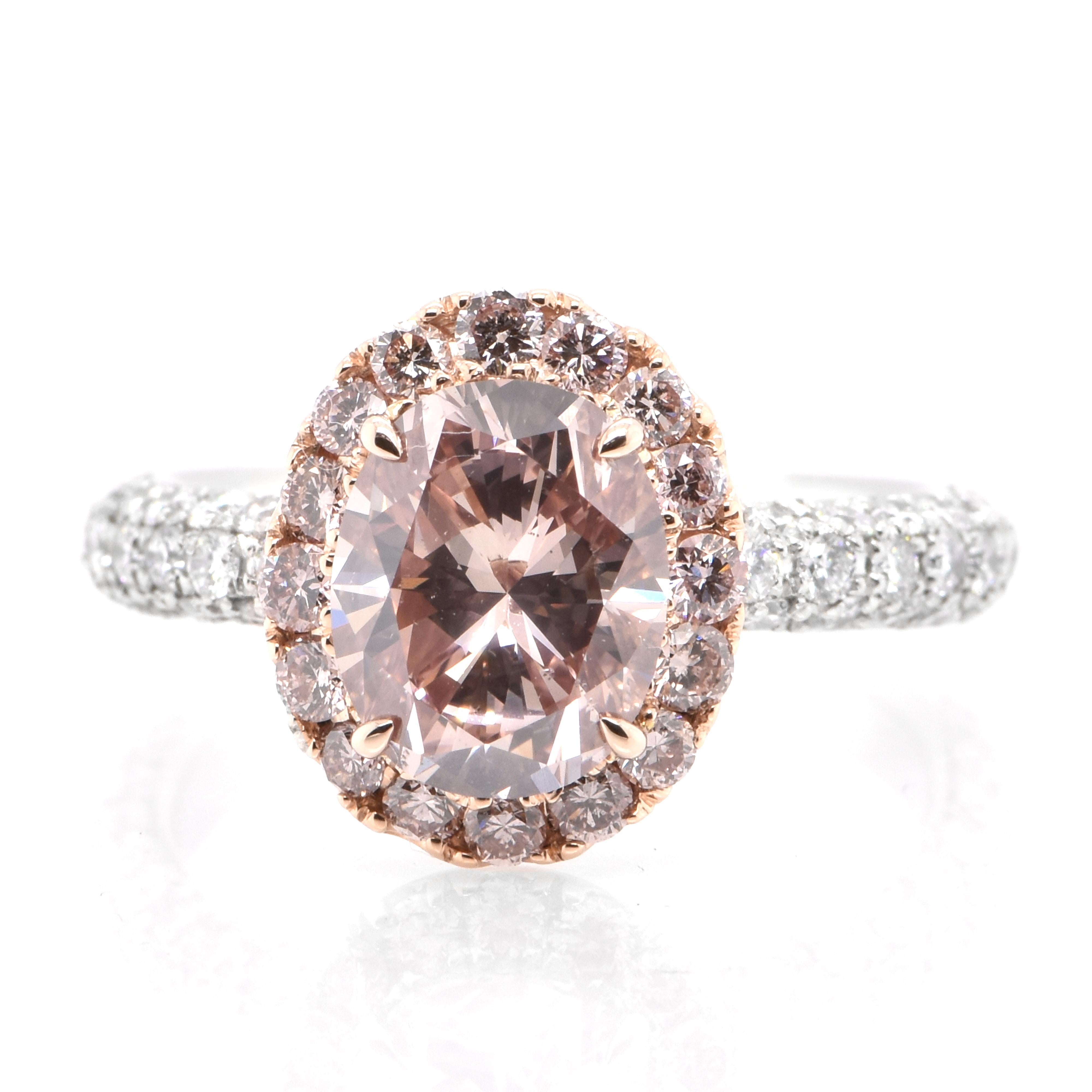 A beautiful ring featuring a CGL Certified Natural 2.245 Carat Fancy Deep Orangish Pink Diamond and 1.30 Carats Diamond accents Ring set in Platinum and 18 Karat Pink Gold. Diamonds have been adorned and cherished throughout human history and date