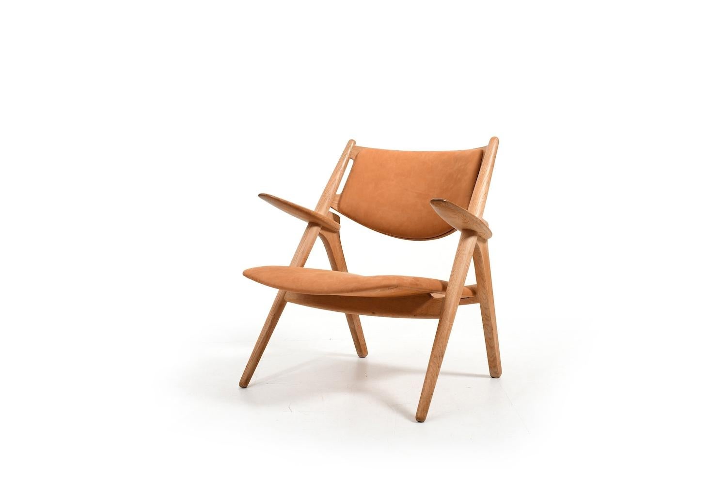 Ch-28 „Sawbuck“ easychair / sawbuck chair  by Hans J. Wegner for Carl Hansen & Søn Denmark 1951. Prod. 1970s in solid oak. New upholstered with cognac leather.