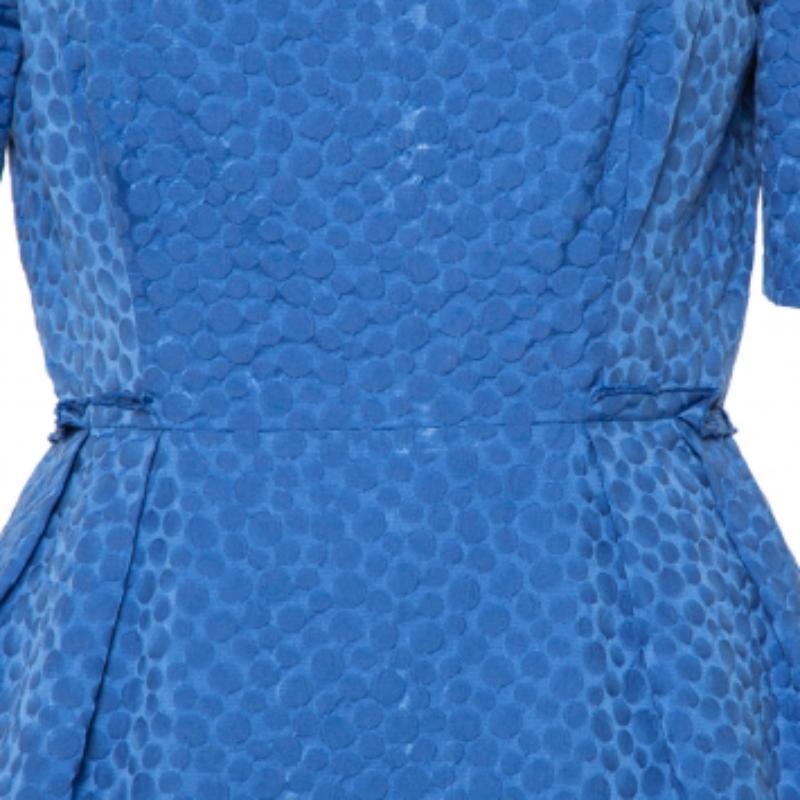 This CH Carolina Herrera dress will offer a refined look when paired with the right kind of accessories. The blue sheath dress has textured detailing all over, short sleeves, a defined waistline, and a back zipper.