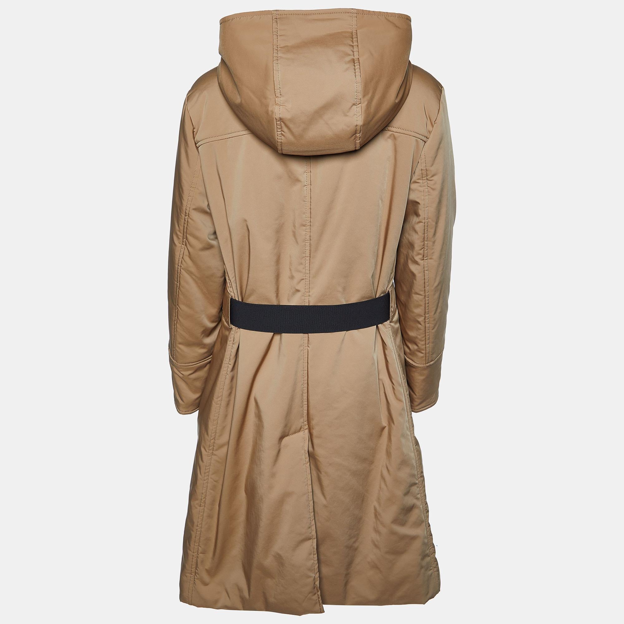 Wrap yourself in warmth and style with the CH Carolina Herrera Brown Hooded Puffer Coat. Crafted with exquisite attention to detail, this coat boasts a rich brown hue and a luxurious puffer design. Its cozy hood offers protection from the elements,