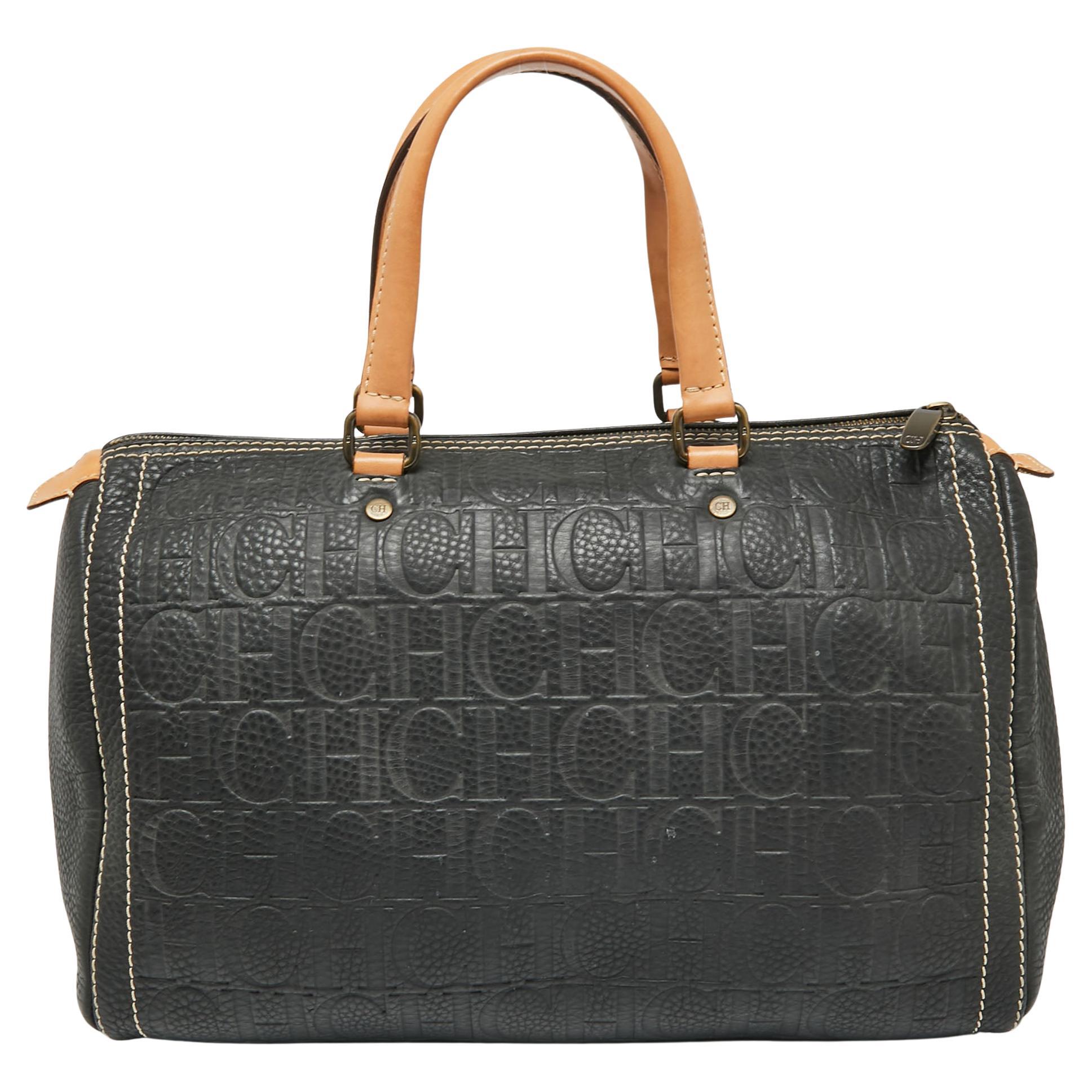 This Andy Boston bag by CH Carolina Herrera comes crafted from dark grey monogram leather and is styled with contrast stitching. It features a top zip closure, two handles, and a spacious suede interior to house your essentials. This bag is a