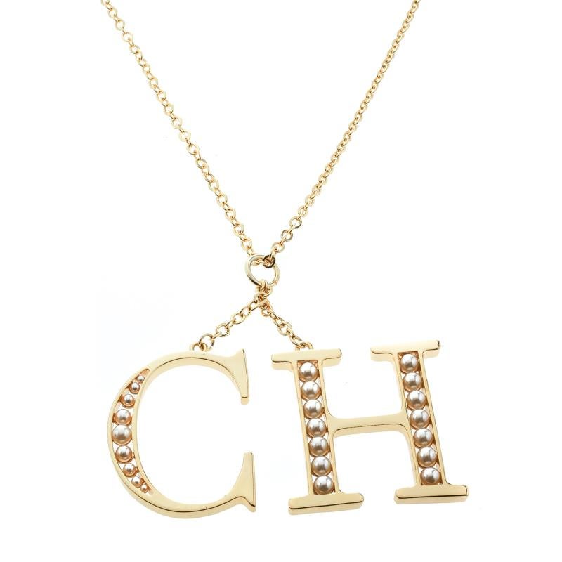 This long necklace from CH Carolina Herrara is sure to catch an eye and make your heart skip a beat. The necklace is crafted from gold-tone metal and assembled with CH logo pendants detailed with faux pearls. Flaunt it with your dresses and