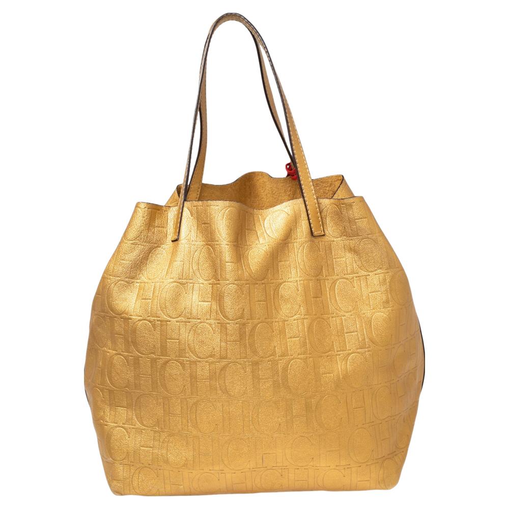 This leather tote in gold CH monogram leather is deceptive in its simplicity. The inside has an open pocket on one side and the handles are of the same leather. The tote folds in at the sides with two straps which give it the ‘Matryoshka’