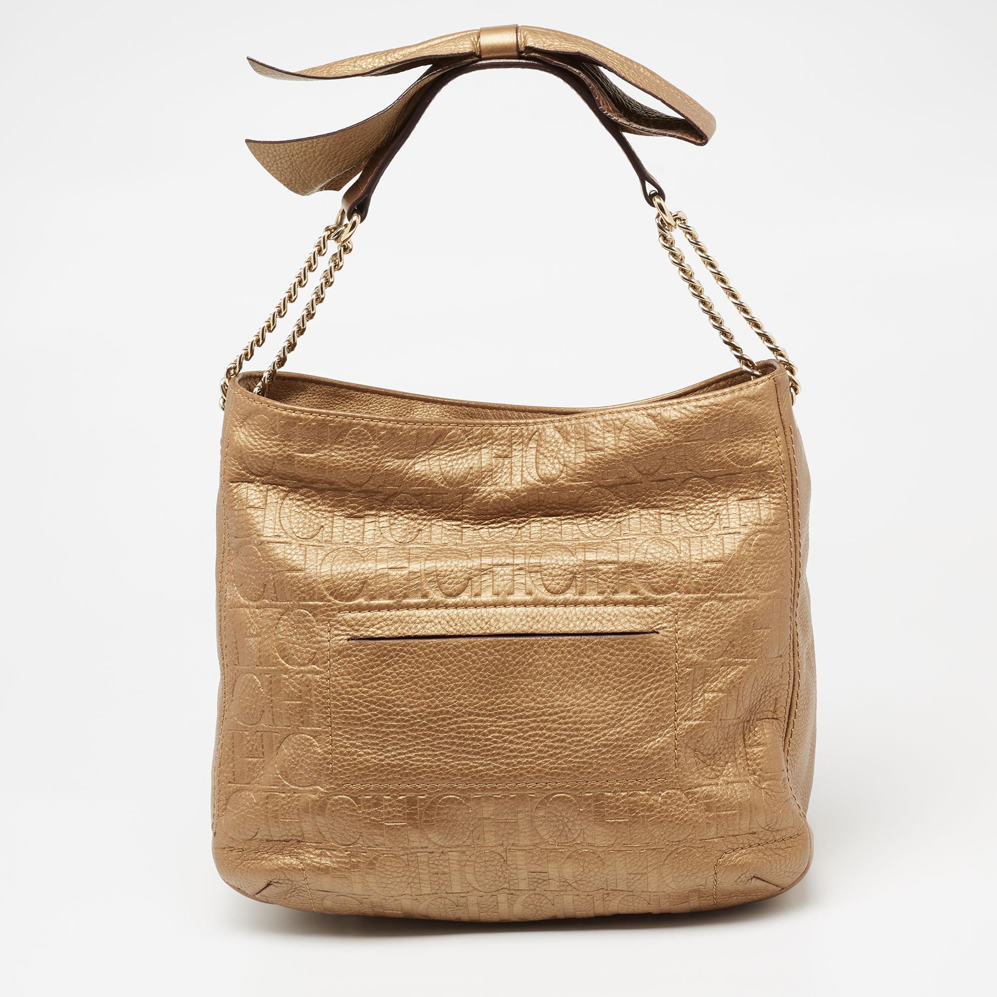 CH Carolina Herrera's hobo has been expertly crafted in sumptuous metallic gold embossed leather. It features a bow motif on the chain handles with comfortable shoulder rests. This stylish bag has a spacious interior with a wall pocket to keep