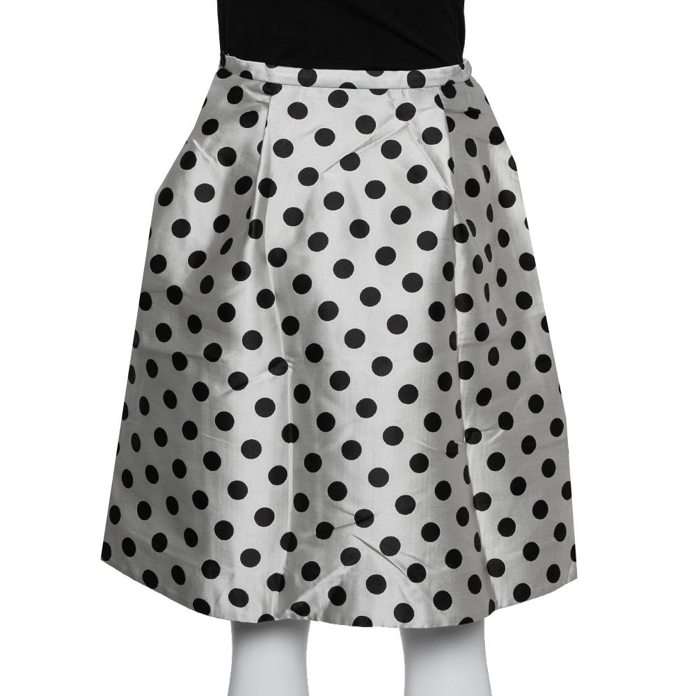 Make room in your closet for this creation from CH Carolina Herrera. Designed for a fashionable look, this skirt is cut from satin and it has polka dots all over. This elegant skirt also features box pleats that fall beautifully from the waistline.

