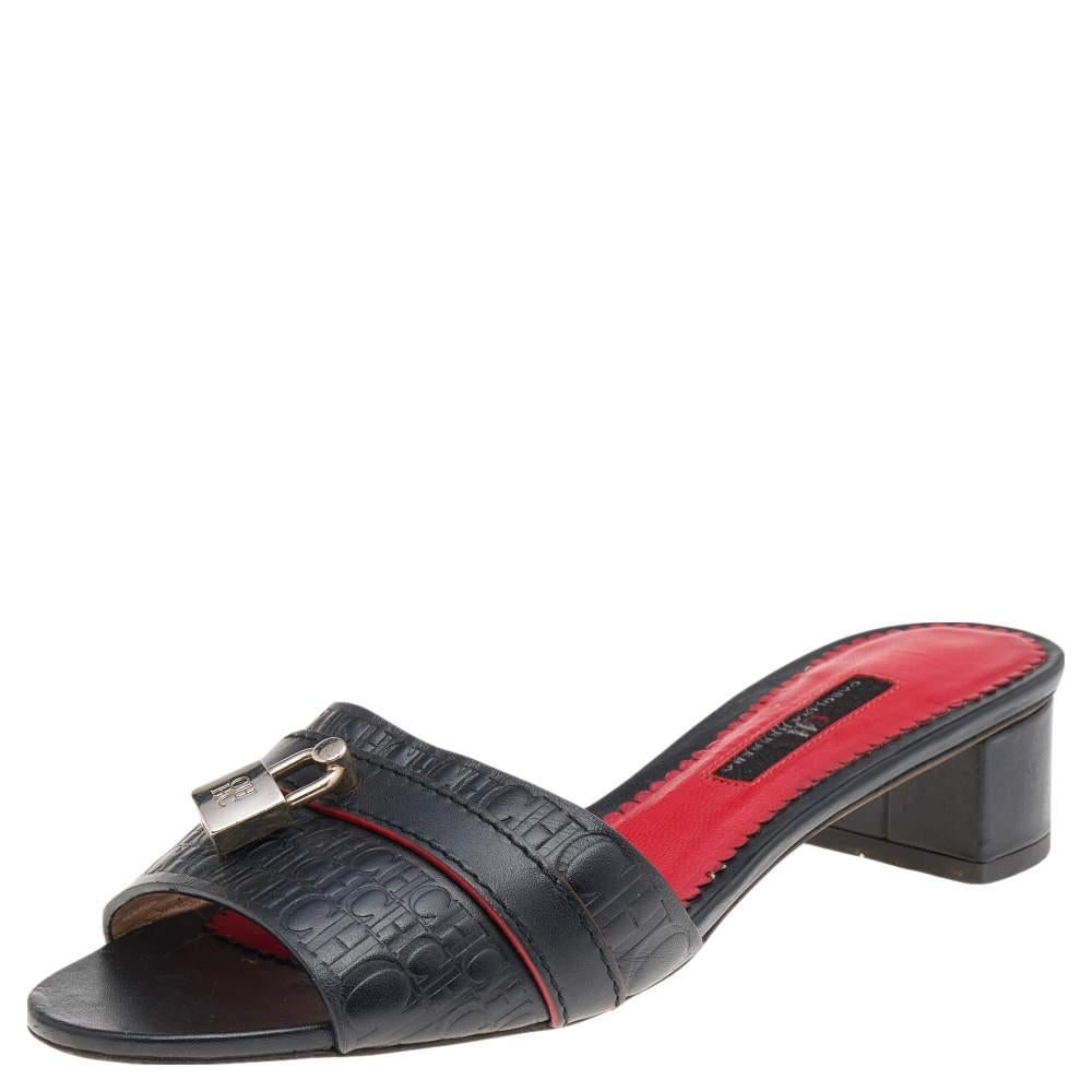 These slide sandals from CH Carolina Herrera will pair well with your casual outfit. They are created using black Monogram-embossed leather with a gold-toned padlock motif attached to the upper. 