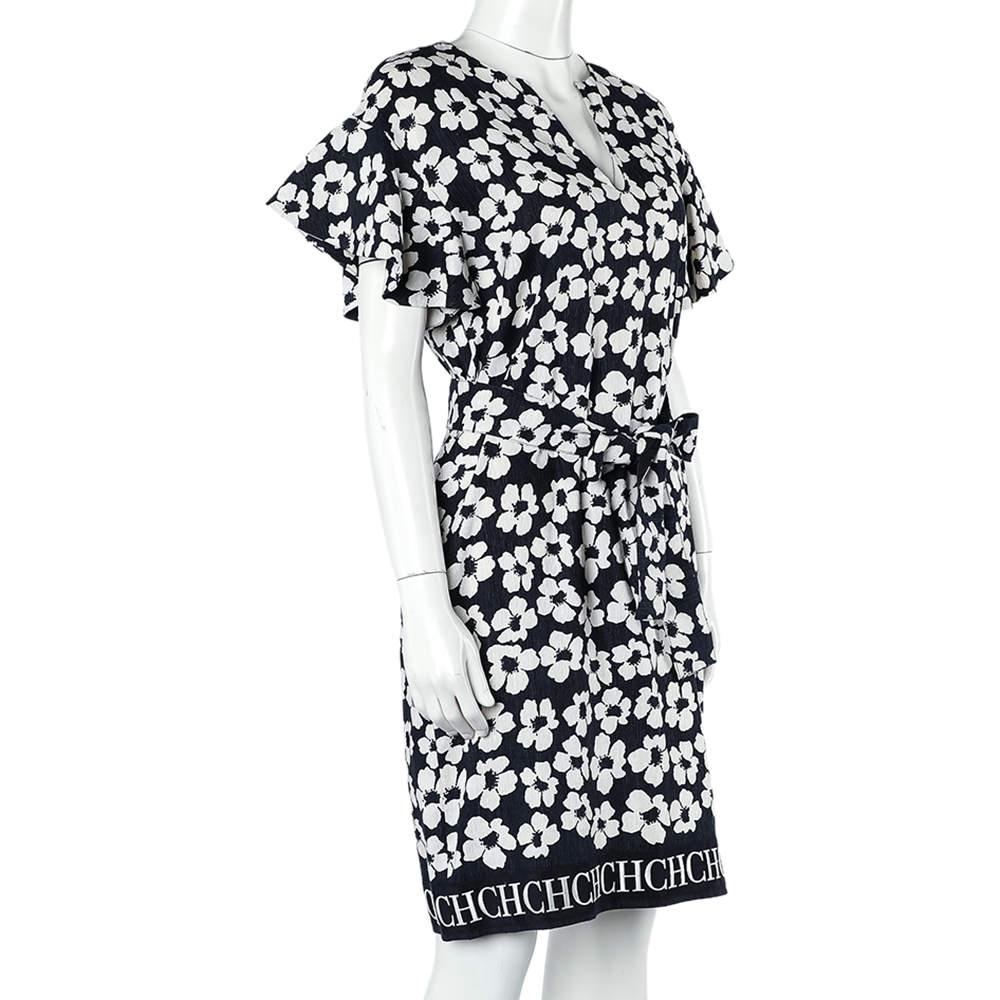 This dress from CH Carolina Herrera is just amazing. This dress shines with a beautiful floral print all over the navy blue background. Featuring a stylish neckline, it comes with a signature-detailed hem and a tie detail at the waist. Team this