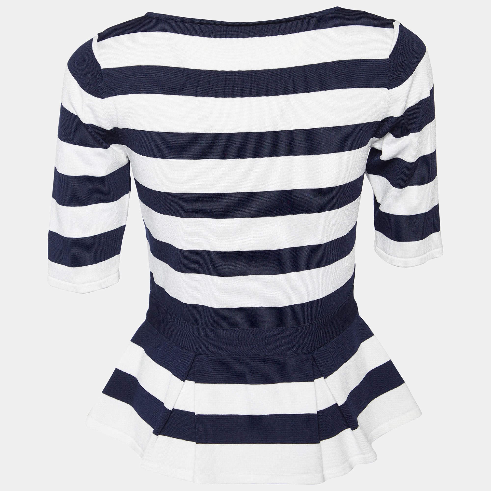 The CH Carolina Herrera top exudes timeless elegance. Crafted with precision, its navy blue and white stripes evoke a nautical charm, while the peplum silhouette adds a flattering flourish. This sophisticated piece seamlessly blends sophistication