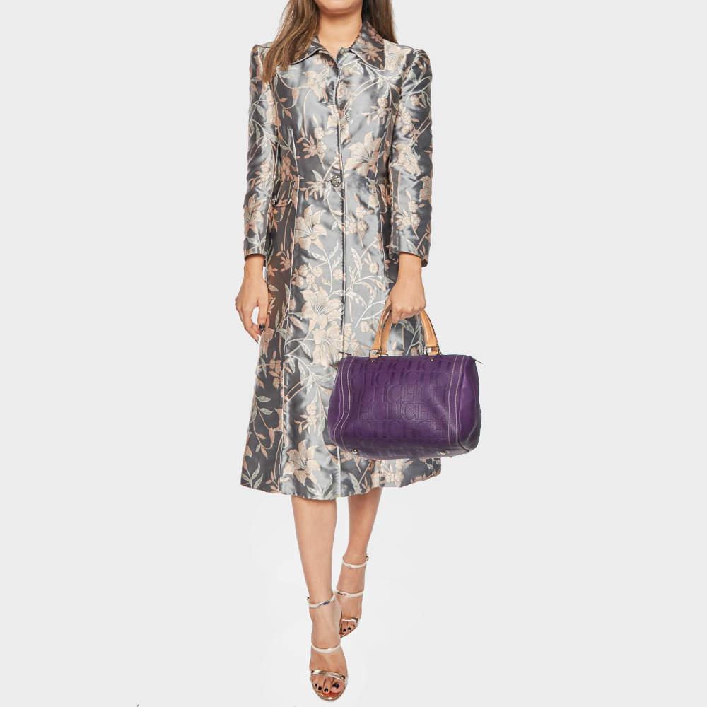 A truly elegant piece to add to your collection this Andy Boston Bag by CH Carolina Herrera comes crafted from purple monogram leather and is styled with neat stitch detailing. It features a top zip closure two handles protective metal feet and a