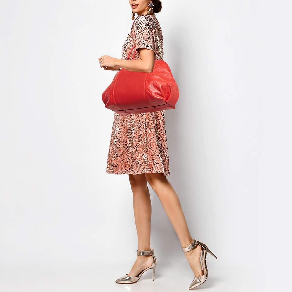 A timeless creation like this Dahlia satchel by Carolina Herrera is rare to find. Crafted from leather in a red hue the bag features panels of monogrammed leather dual handles and a chain link shoulder strap. The creation is complete with a padlock