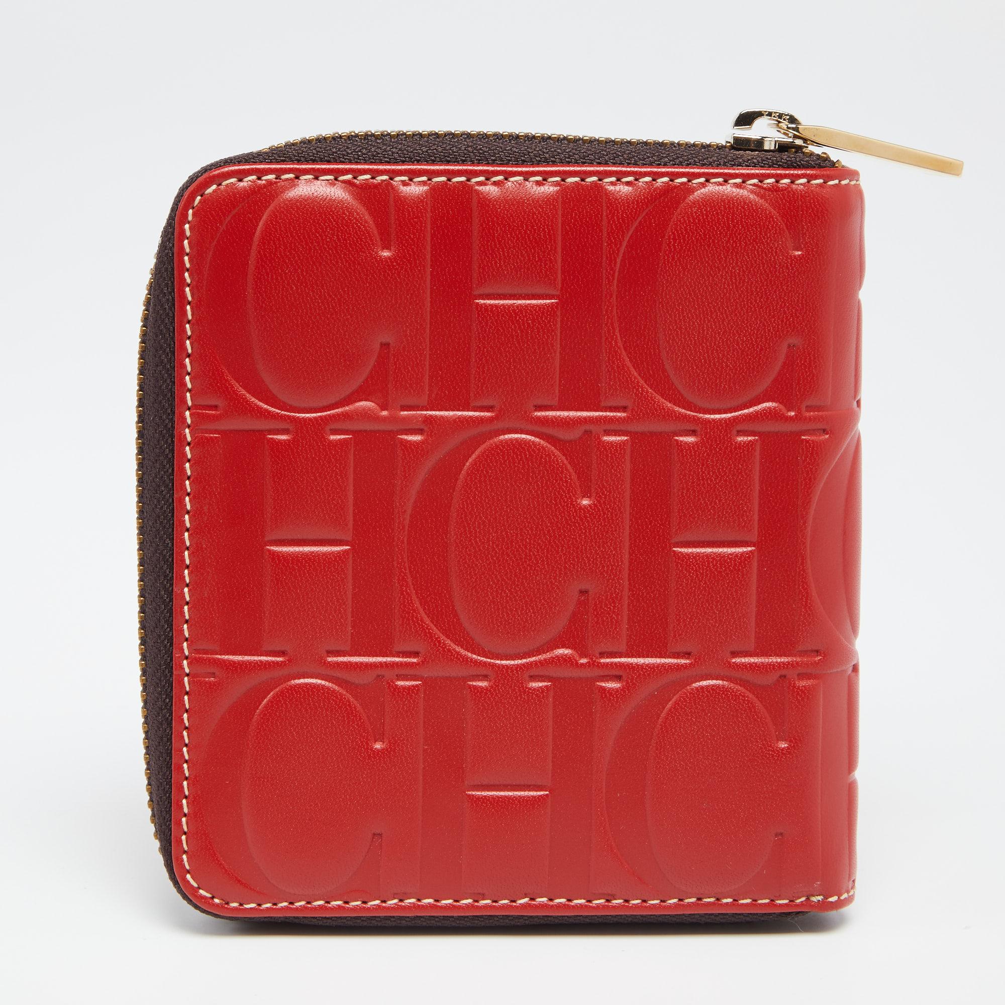 The monogram leather construction gives this wallet an instant look of luxury. It features a red shade and a gold-tone zipper to secure the well-equipped interior. This CH Carolina Herrera creation can easily fit into your everyday bags.

Includes: