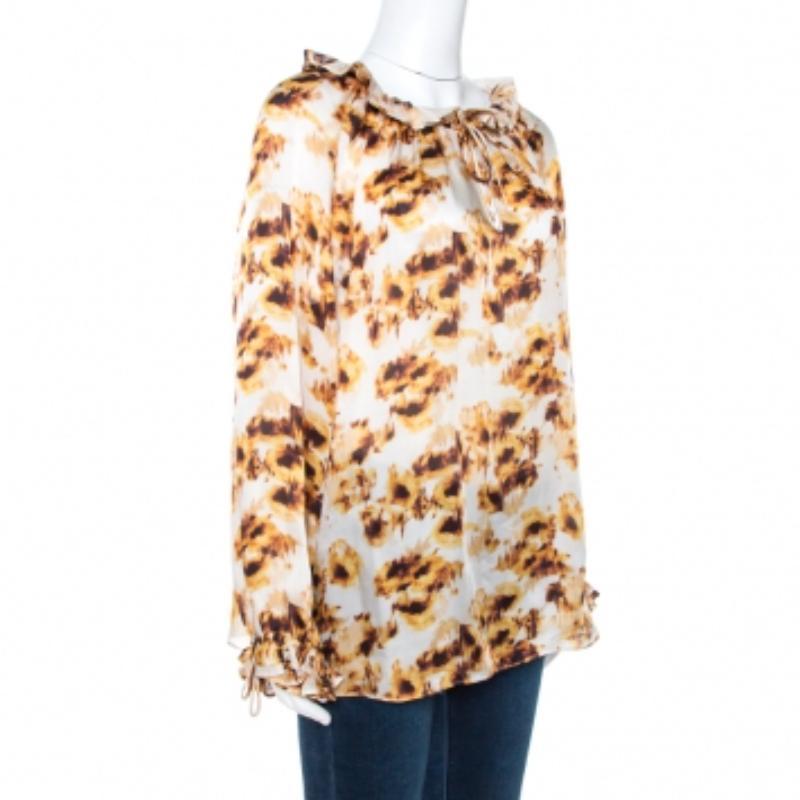 Another classic from the house of CH Carolina Herrera, this blouse is a summer staple. It is designed with a beautiful print all over in the shades of white and brown. This unique silk blouse caters to boho-luxe designs for the modern woman.