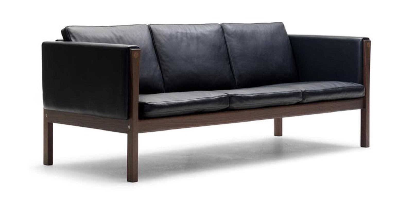 Hans J. Wegner designed the CH163 sofa in 1965, using a down filling for luxurious comfort. This large, three-seat sofa neatly exemplifies how Wegner often highlighted structural details to great effect. 

Additional Info:
Material: Leather and