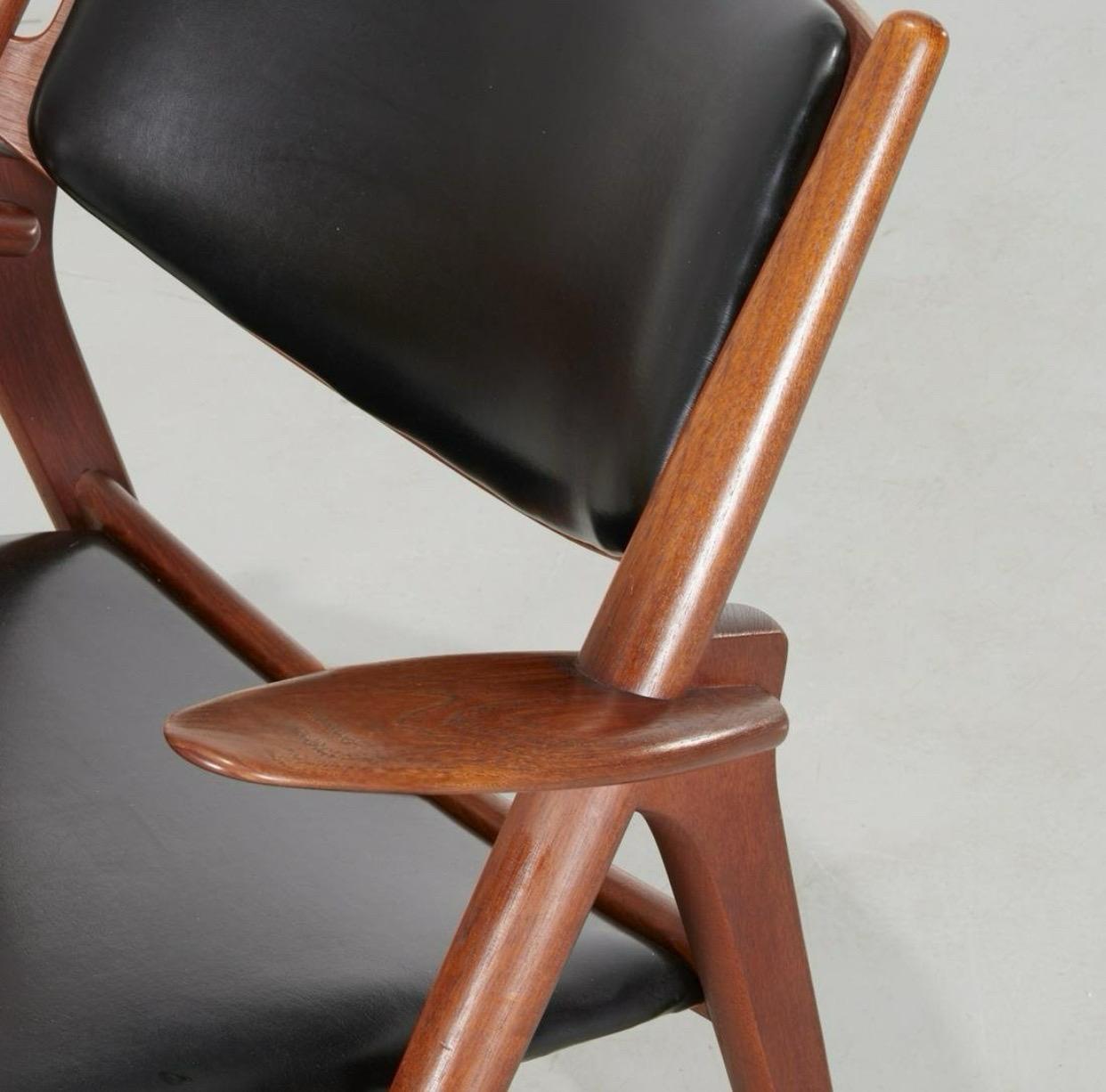 This is a “Sawbuck” chair design by Hans Wegner and hand built  by the Carl Hansen and Son funiture manufacturers in Denmark. Frame consists of solid walnut wood in a modified X shape of the arms and legs. The seat and back are covered in an elegant