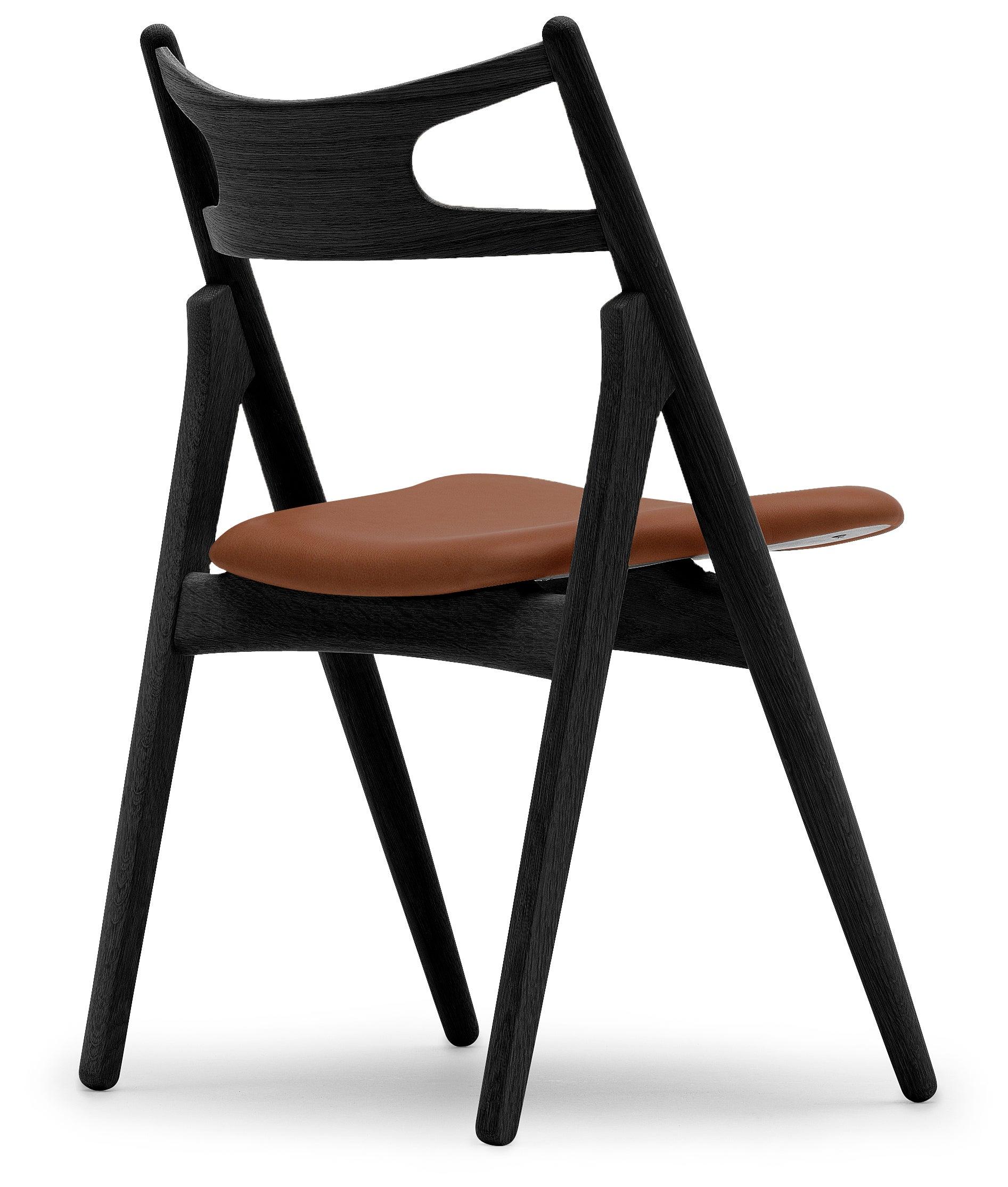 The CH29P Sawbuck chair, designed by Hans J. Wegner, has clean, simple lines and a unique construction. The seat is significantly wider at the front, and - along with the very curved back â€“ingeniously enhances comfort in various sitting positions