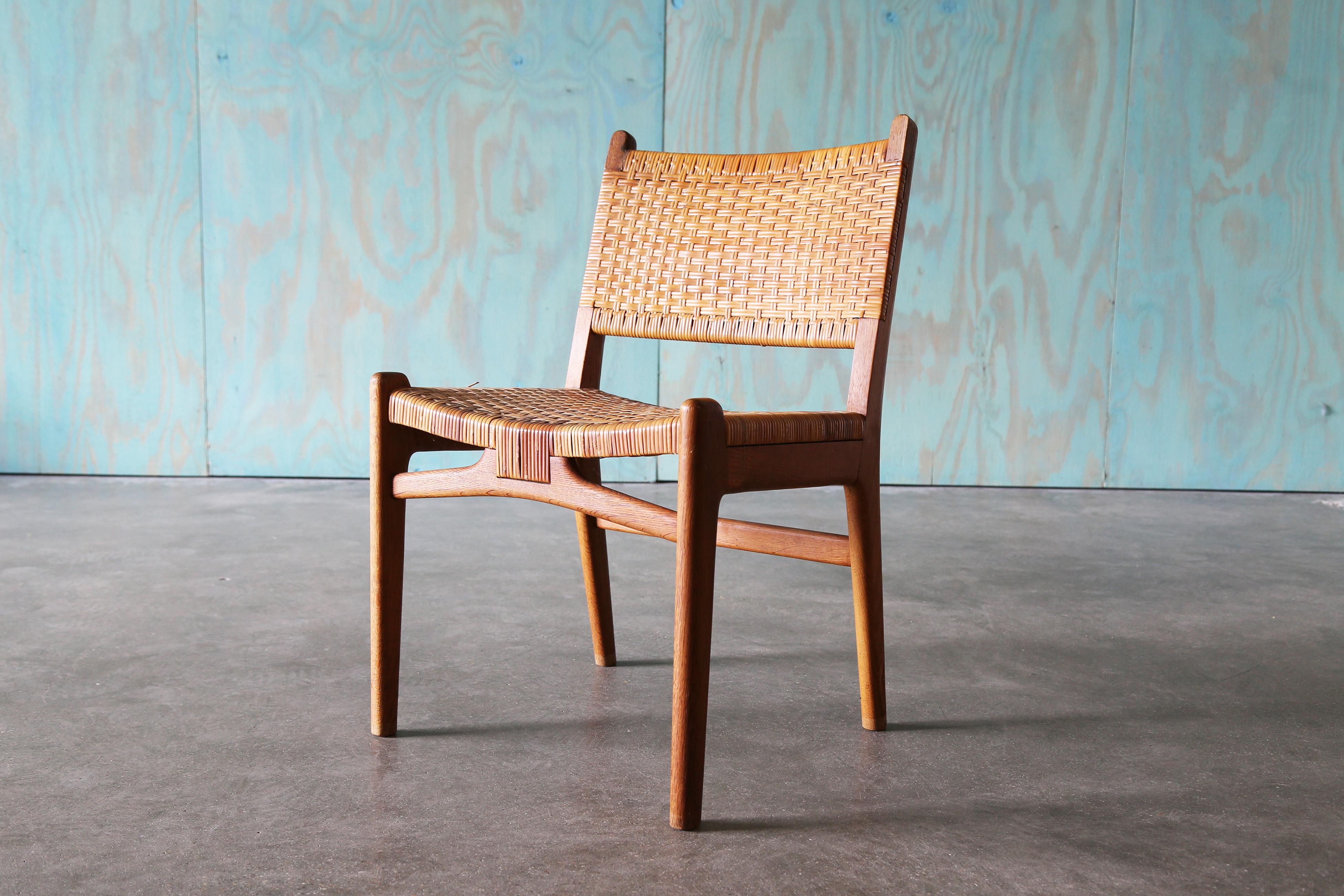 A danish modern classic , the CH31 chair designed by Hans J. Wegner for Carl Hansen and Søn. Cane and Oak, featuring a woven seat and back. A rare and coveted design this chair would work well with designs from Finn Juhl, Ib Kofod Larsen, Borge