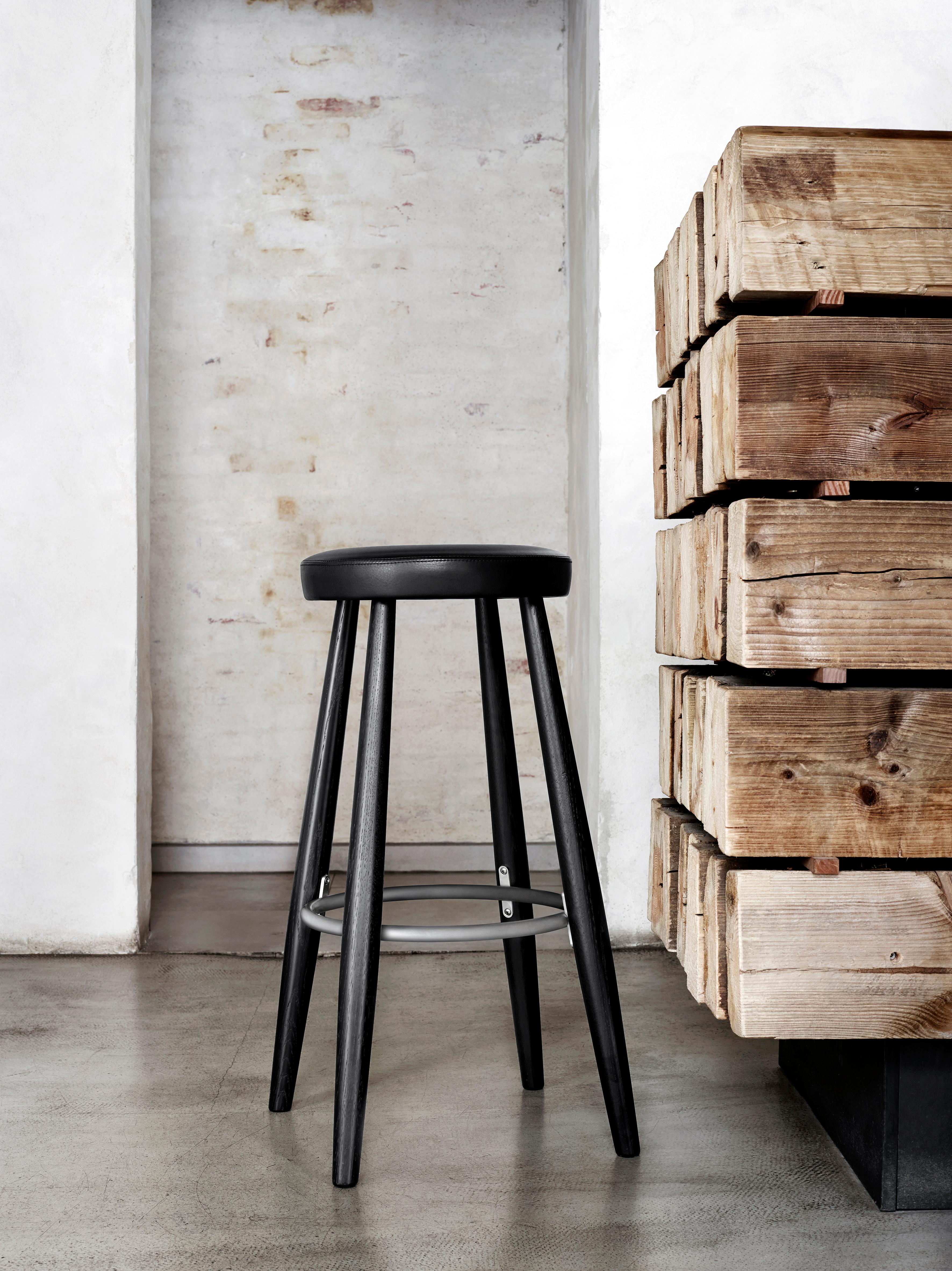 The CH56 barstool in solid wood, leather and stainless steel designed by Hans J. Wegner in 1985 is simple, practical and superbly-crafted for great comfort and an appealing atmosphere in any space.

Dimensions: 15.4in D x 15.4in W x 29.9in H
The