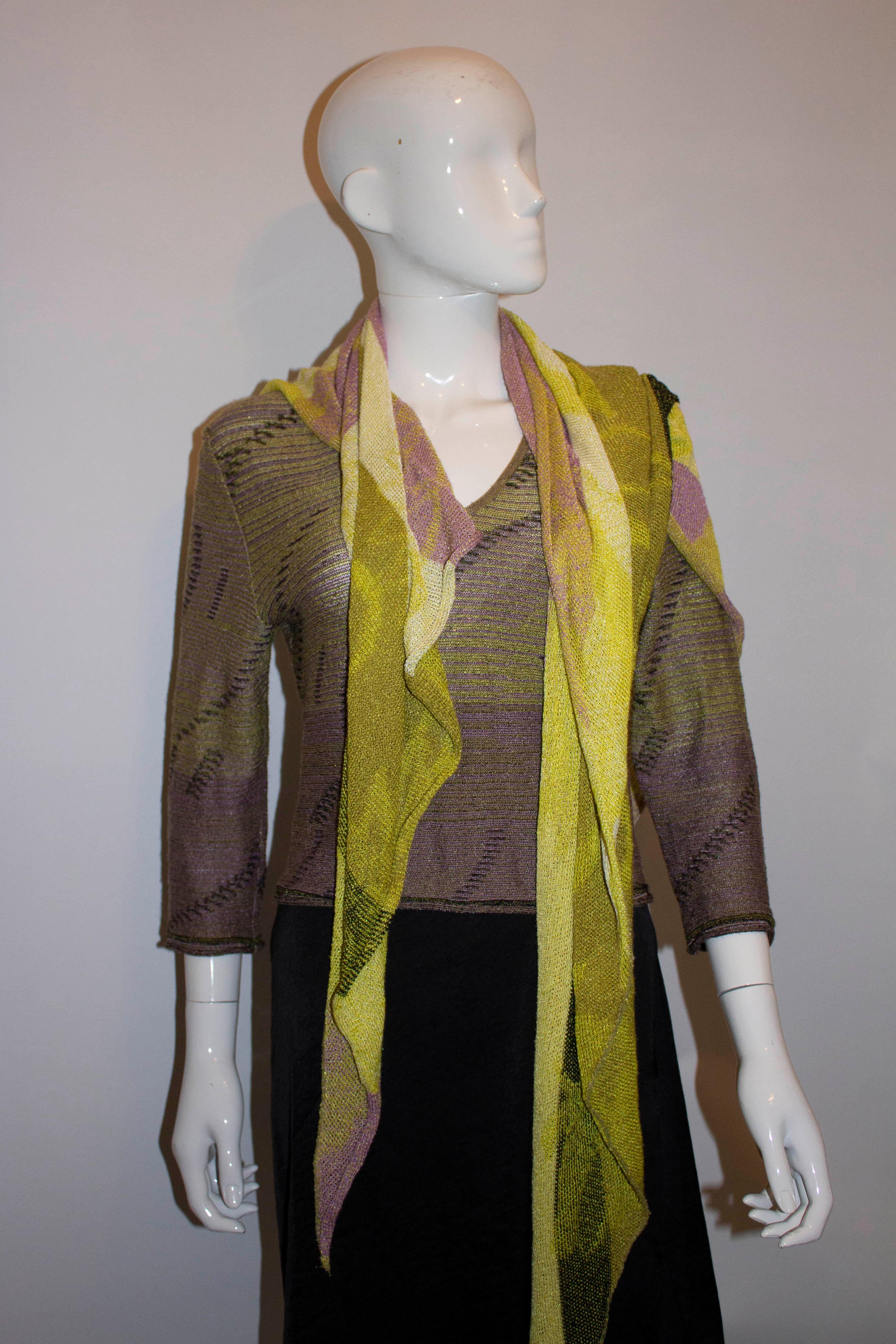 A pretty v neck jumper and matching scarf in  a pretty yellow and purple mix. 
Measurements:  Jumper  Bust 35'' , length 23'' Scarf  Measurements 96'' x 83'' x 80''