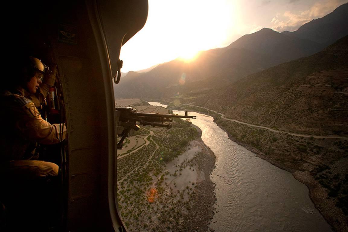 Chad Hunt Landscape Photograph - A view from the door of a Blackhawk helicopter over the Kabul River