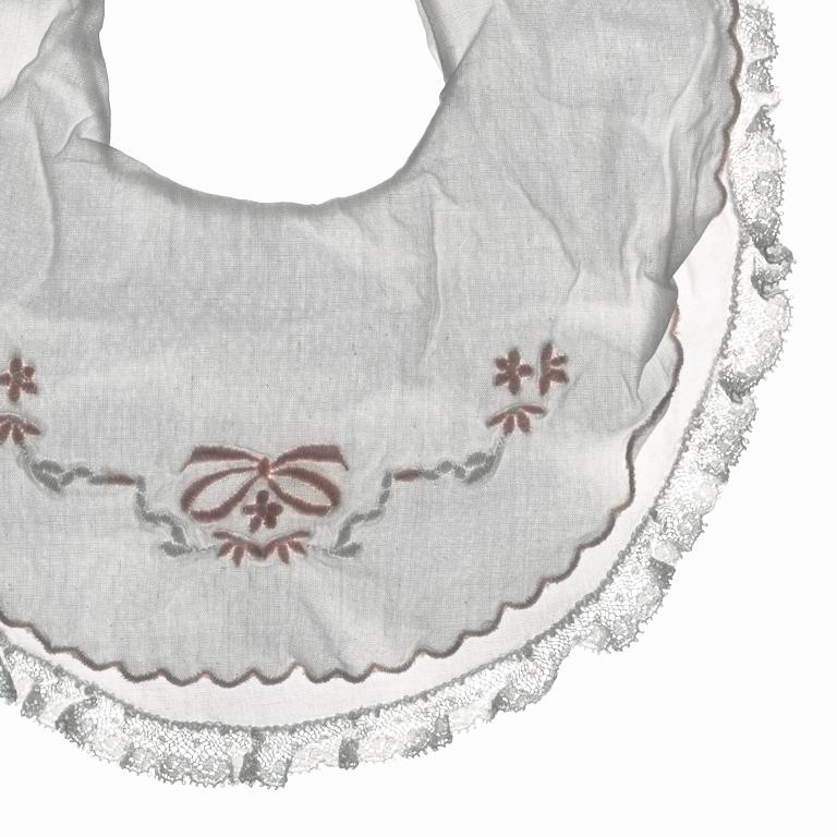 Contemporary scanograph still life photograph of a child's bib on a white background.
