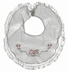 Aliboo Bib: Still Life Photograph of White & Pink Child's Embroidered Clothing