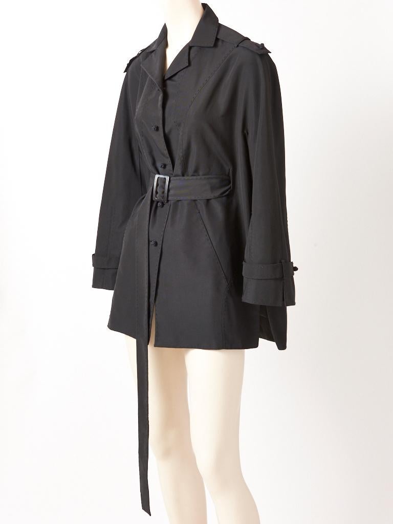 Chado Ralph Rucci Couture, black silk faille, belted jacket, having Rucci signature, hand top stitching detail, and knotted silk button closures. Jacket is belted in the front leaving the back free. There are side vents with slash pockets. Small