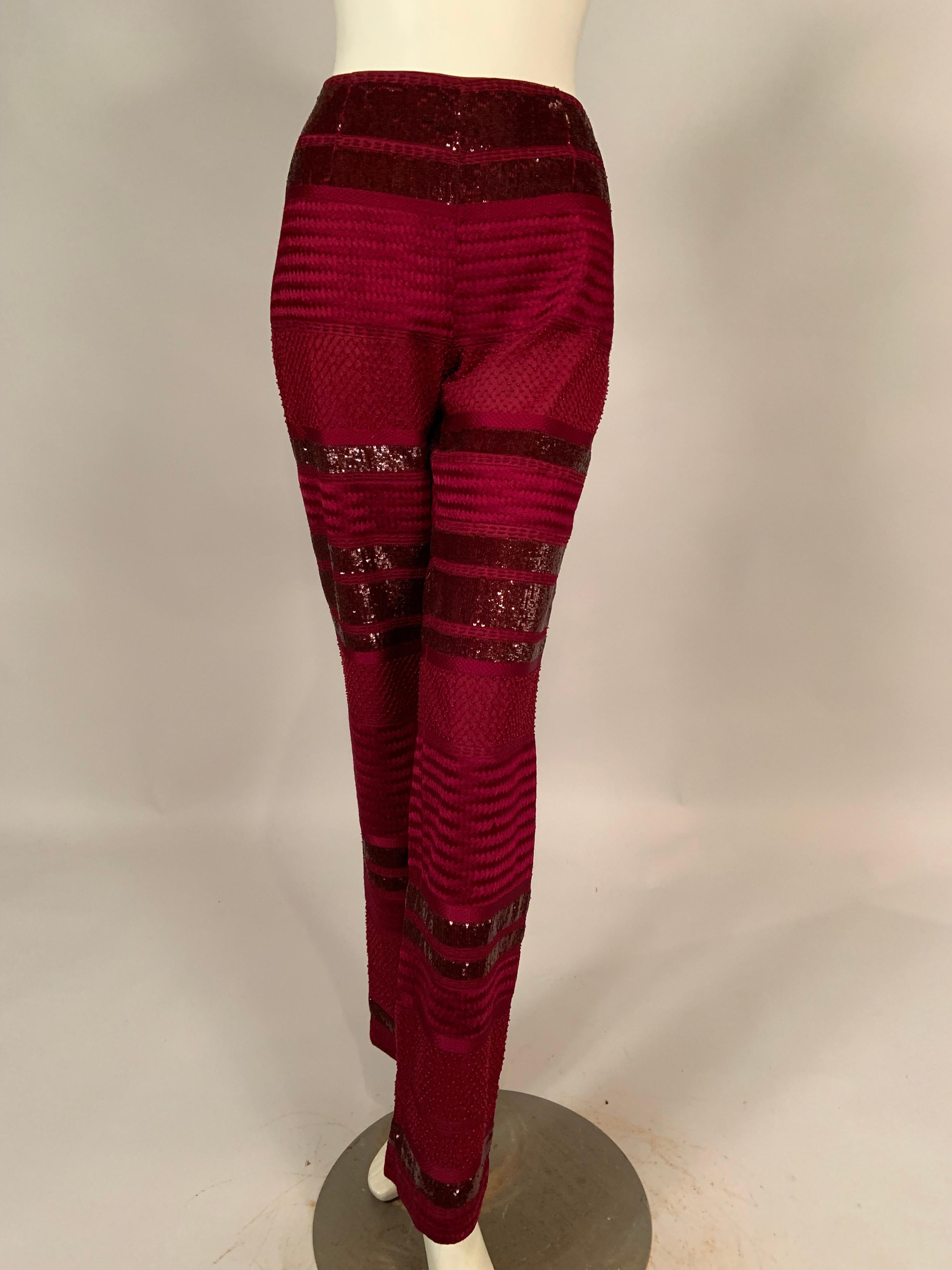 These pants are all about the fabric, the cut and design of the pants is spare and elegant. No waistband, no pockets, and an invisible left side zipper allows the fabric to be the star. Cranberry red silk is beaded with wide bands of the tiniest