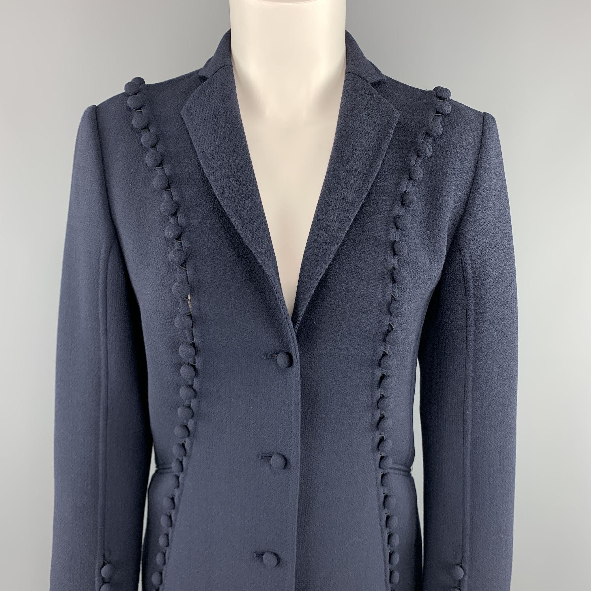 CHADO RALPH RUCCI blazer comes in a muted navy blue crepe wool with a notch lapel, single breasted three button front, and slit cutout trim with fabric button embellishments. Made in USA.Excellent
 Pre-Owned Condition. 
 

 Marked:  2 
 

