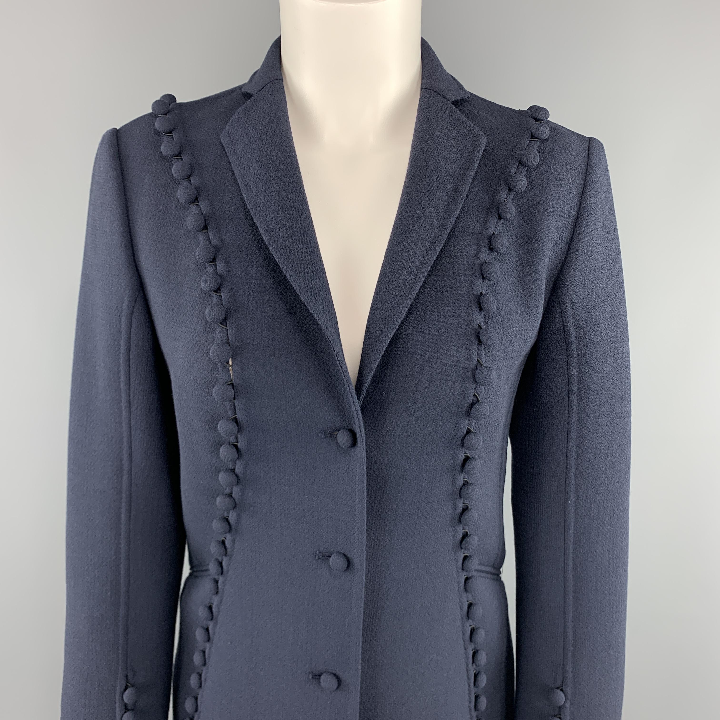 CHADO RALPH RUCCI blazer comes in a muted navy blue crepe wool with a notch lapel, single breasted three button front, and slit cutout trim with fabric button embellishments. Made in USA.

Excellent Pre-Owned Condition.
Marked: